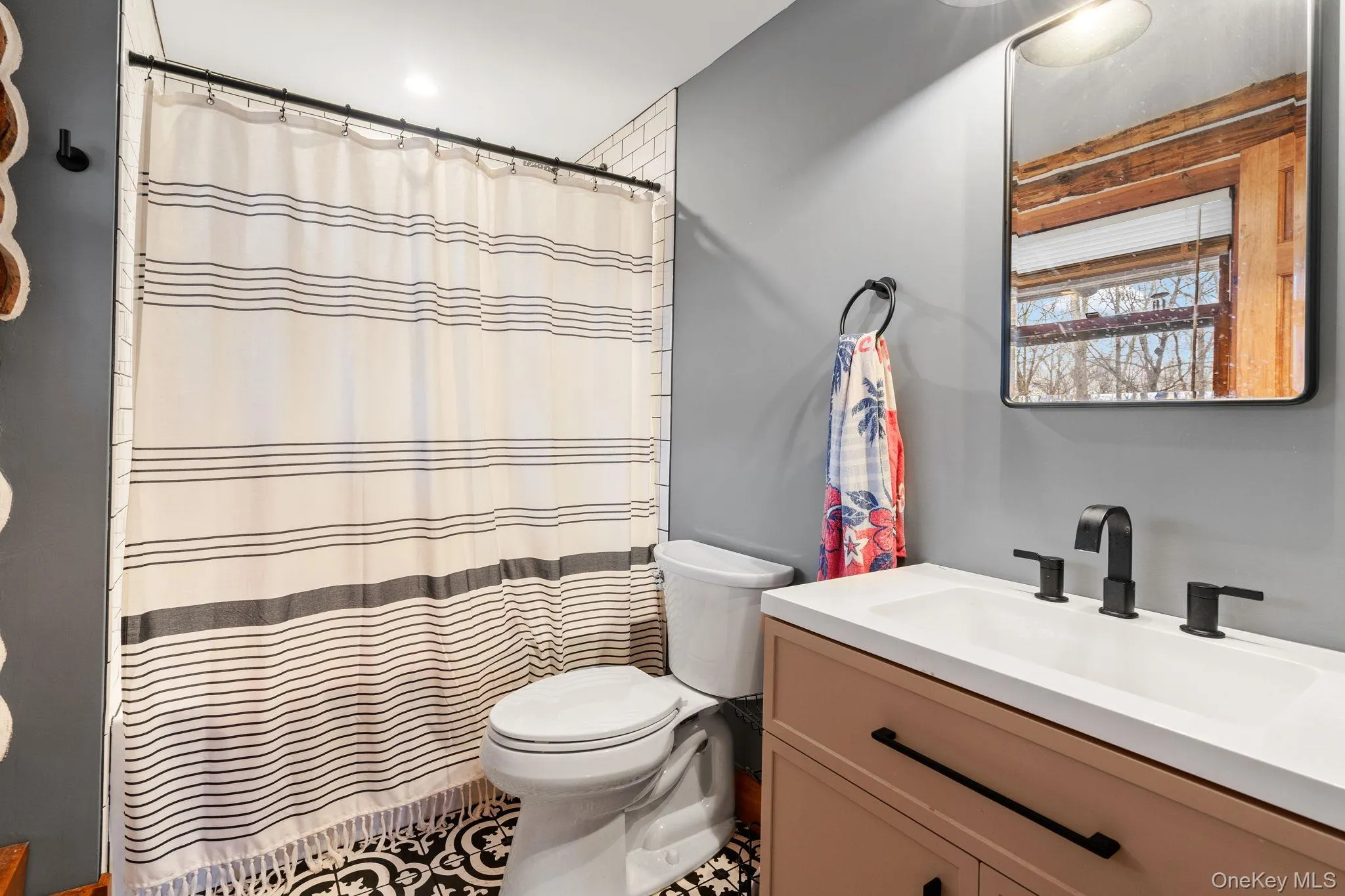 Full bath with vanity, tile patterned floors, and curtained shower Full bath with vanity, tile patterned floors, and curtained shower