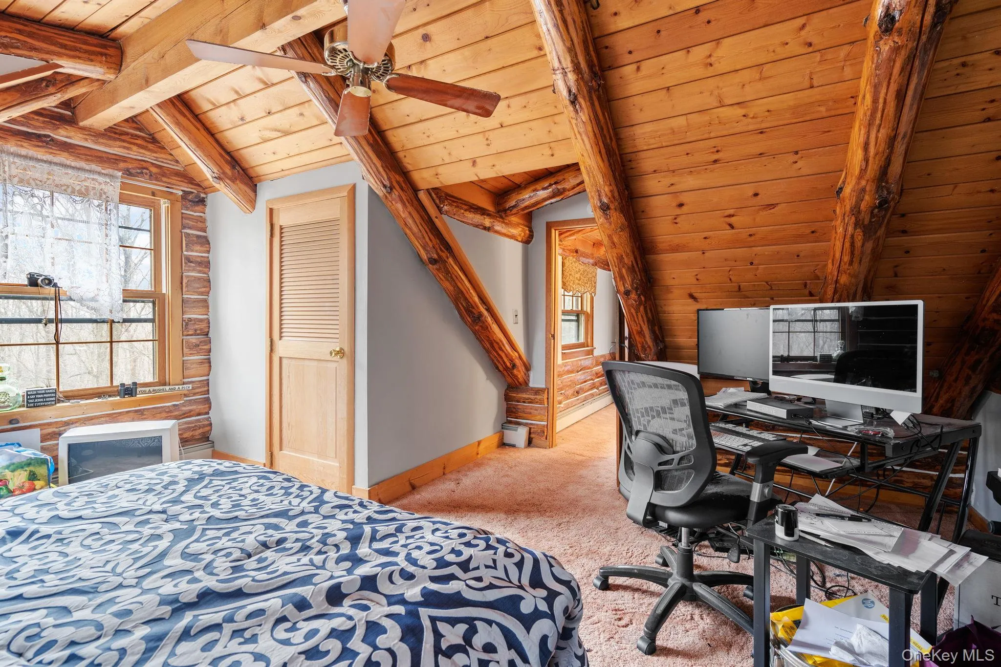 Bedroom featuring multiple windows, wood ceiling, carpet flooring, and a desk Bedroom featuring multiple windows, wood ceiling, carpet flooring, and a desk