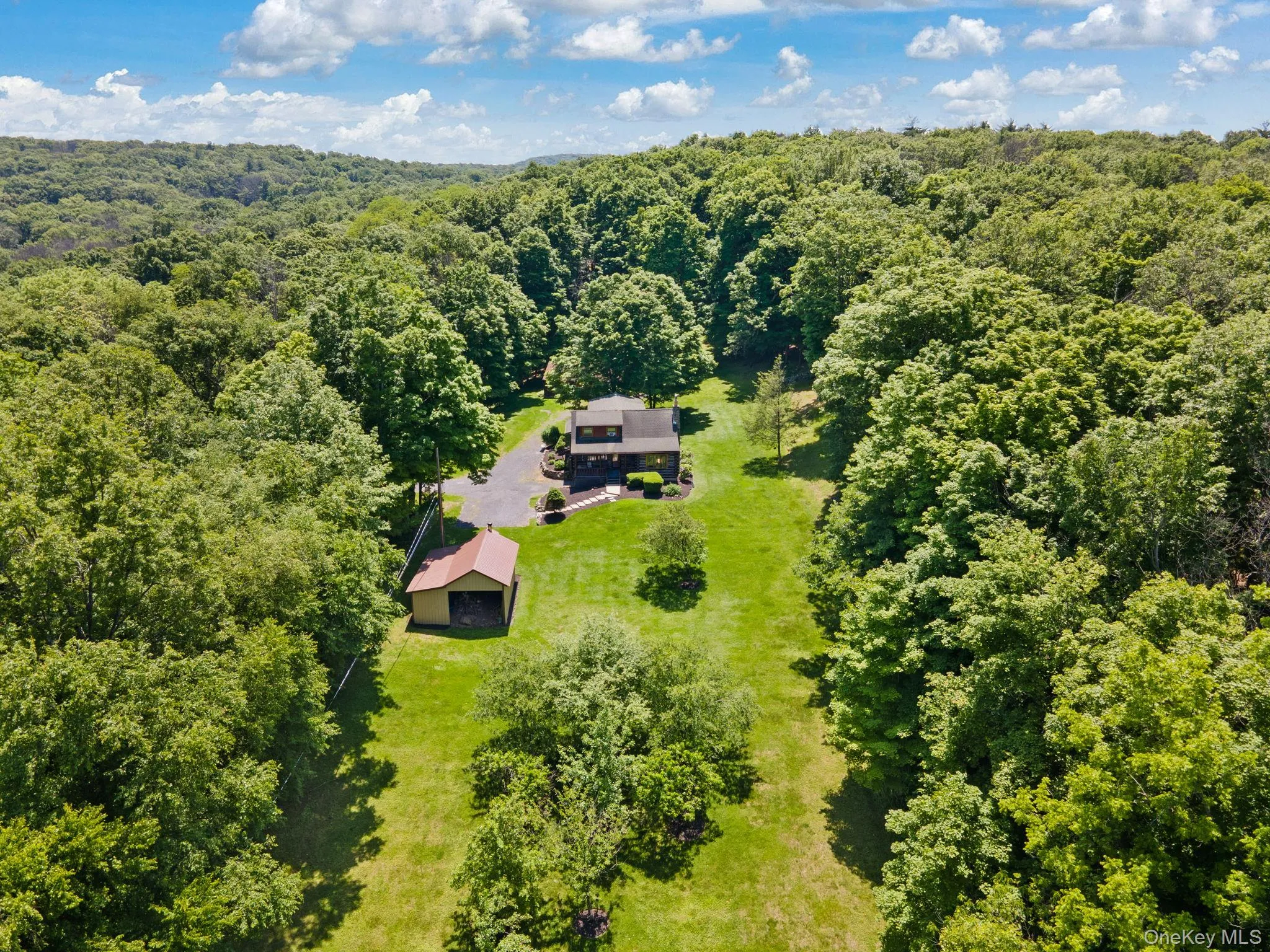 Aerial view of property and surrounding area featuring a forest Aerial view of property and surrounding area featuring a forest