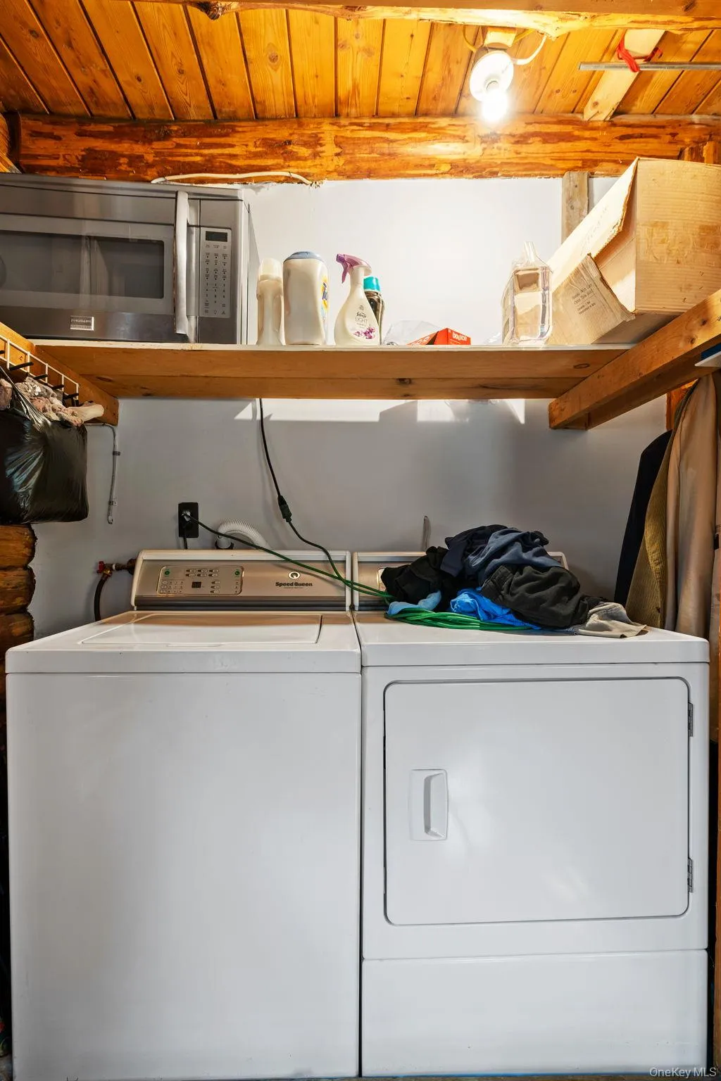 Laundry room with wooden ceiling and washing machine and dryer Laundry room with wooden ceiling and washing machine and dryer