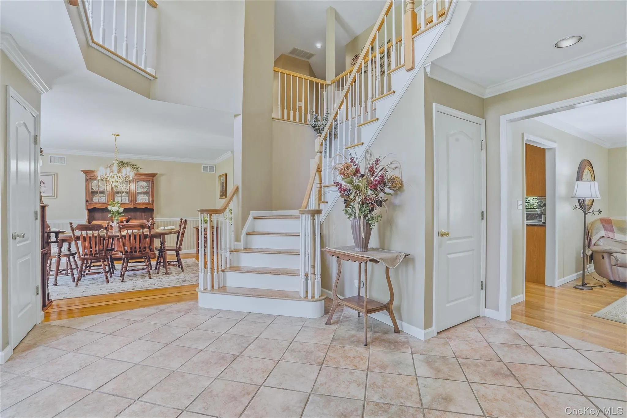 Grand two-story foyer highlighted by a dramatic staircase, creating a stunning first impression. Grand two-story foyer highlighted by a dramatic staircase, creating a stunning first impression.