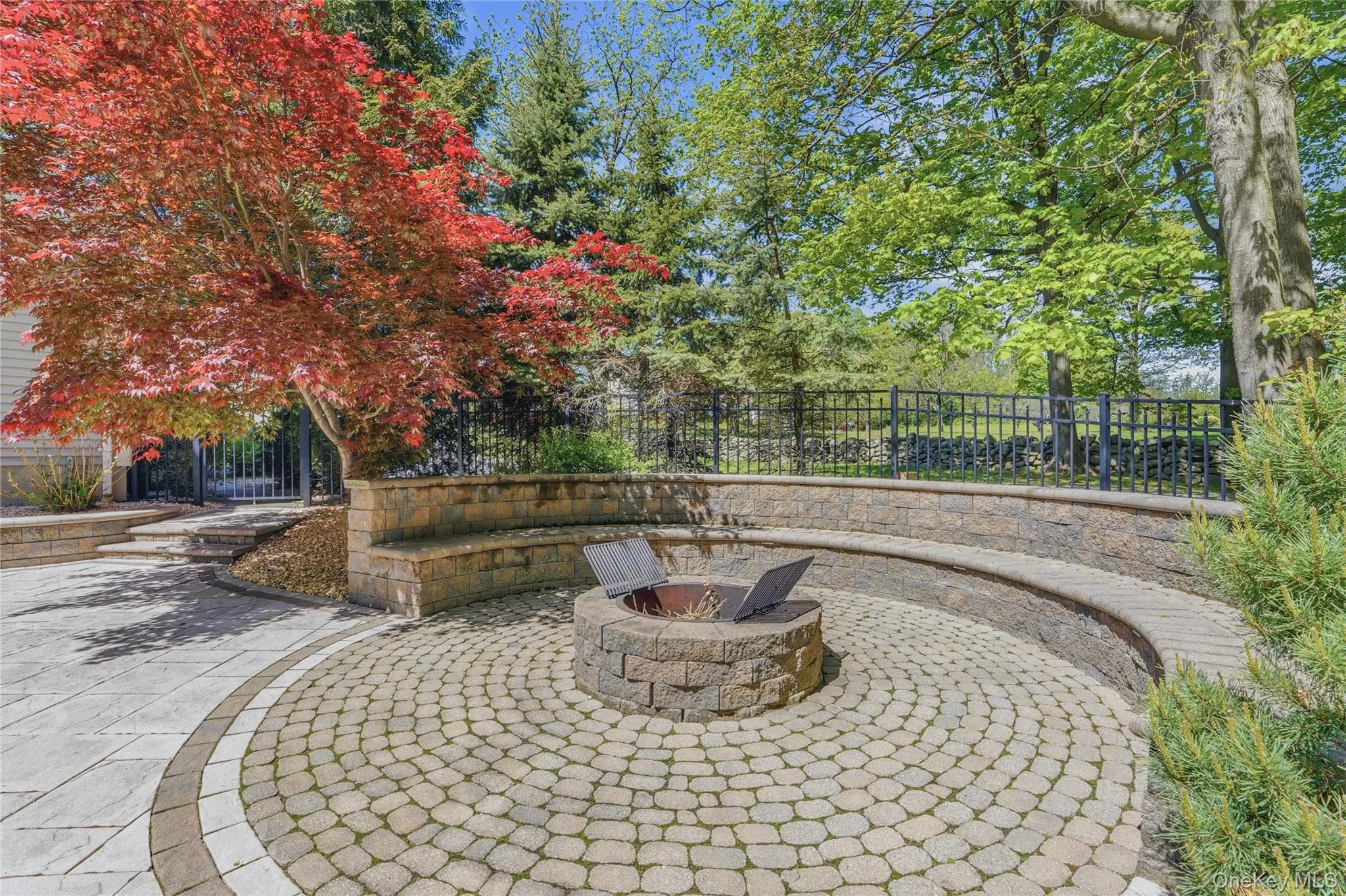 Outdoor built in fire Pit with custom paving stones and built in seating for year round enjoyment. Outdoor built in fire Pit with custom paving stones and built in seating for year round enjoyment.