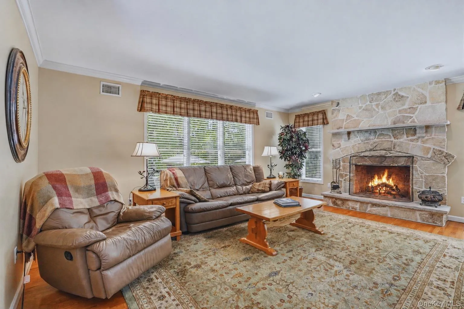Inviting family room with floor-to-ceiling stone wood-burning fireplace. Inviting family room with floor-to-ceiling stone wood-burning fireplace.