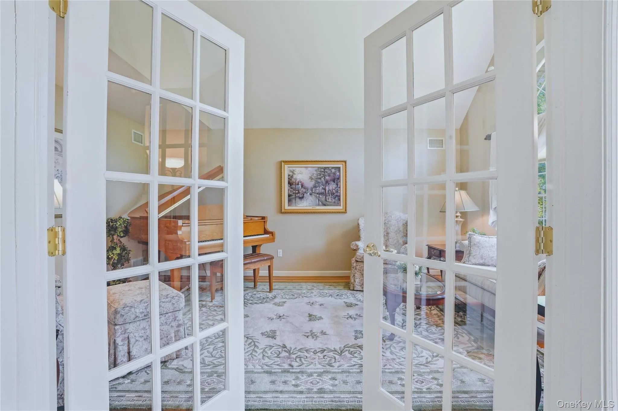 Formal living room with loft ceiling and french doors. Formal living room with loft ceiling and french doors.