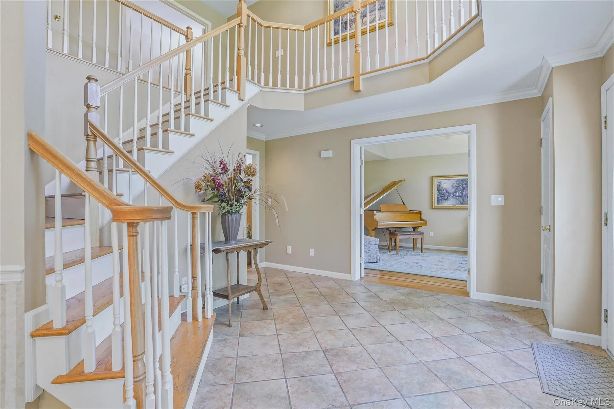 Grand foyer with tile flooring leading into formal living room. Grand foyer with tile flooring leading into formal living room.
