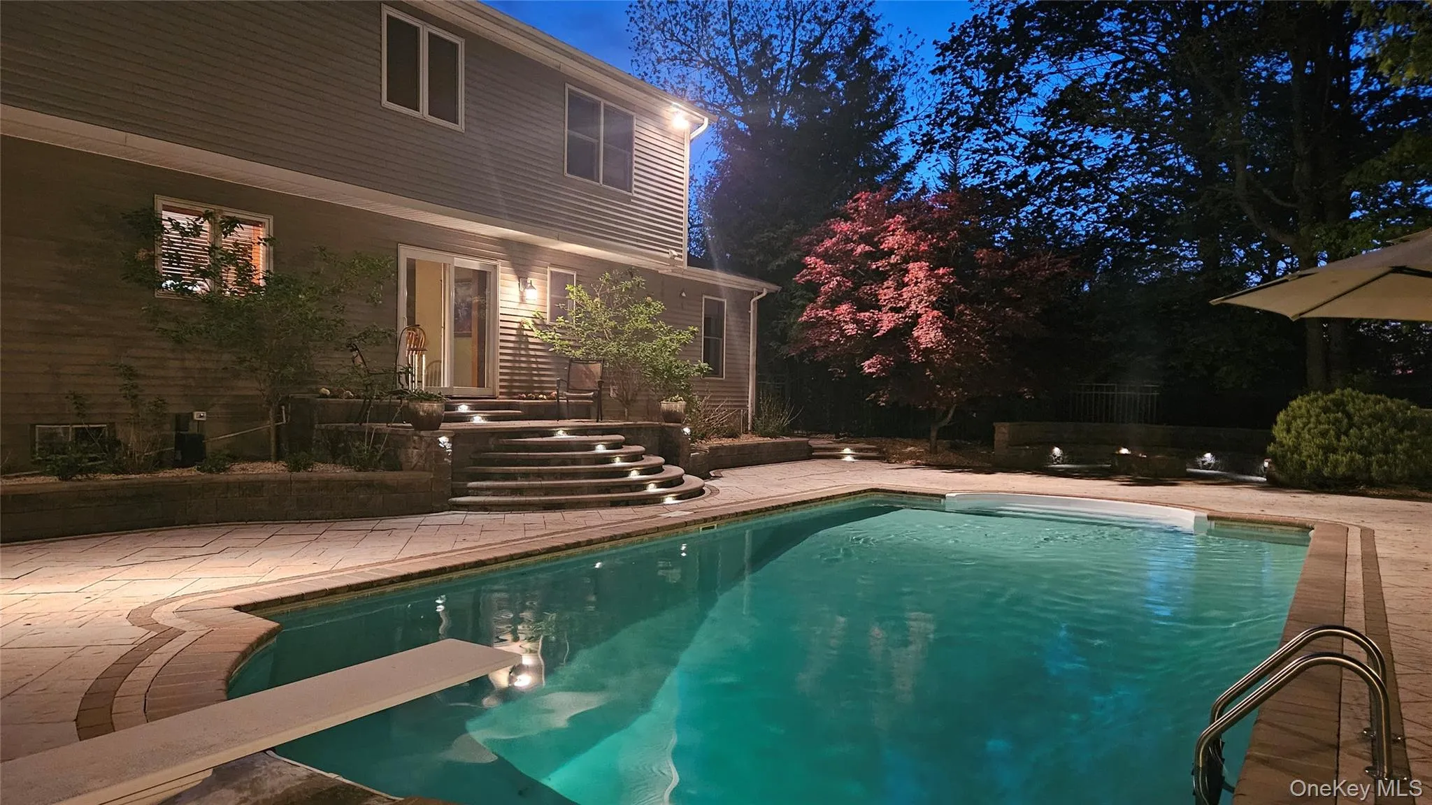 Pool with surrounding landscape lighting. Pool with surrounding landscape lighting.