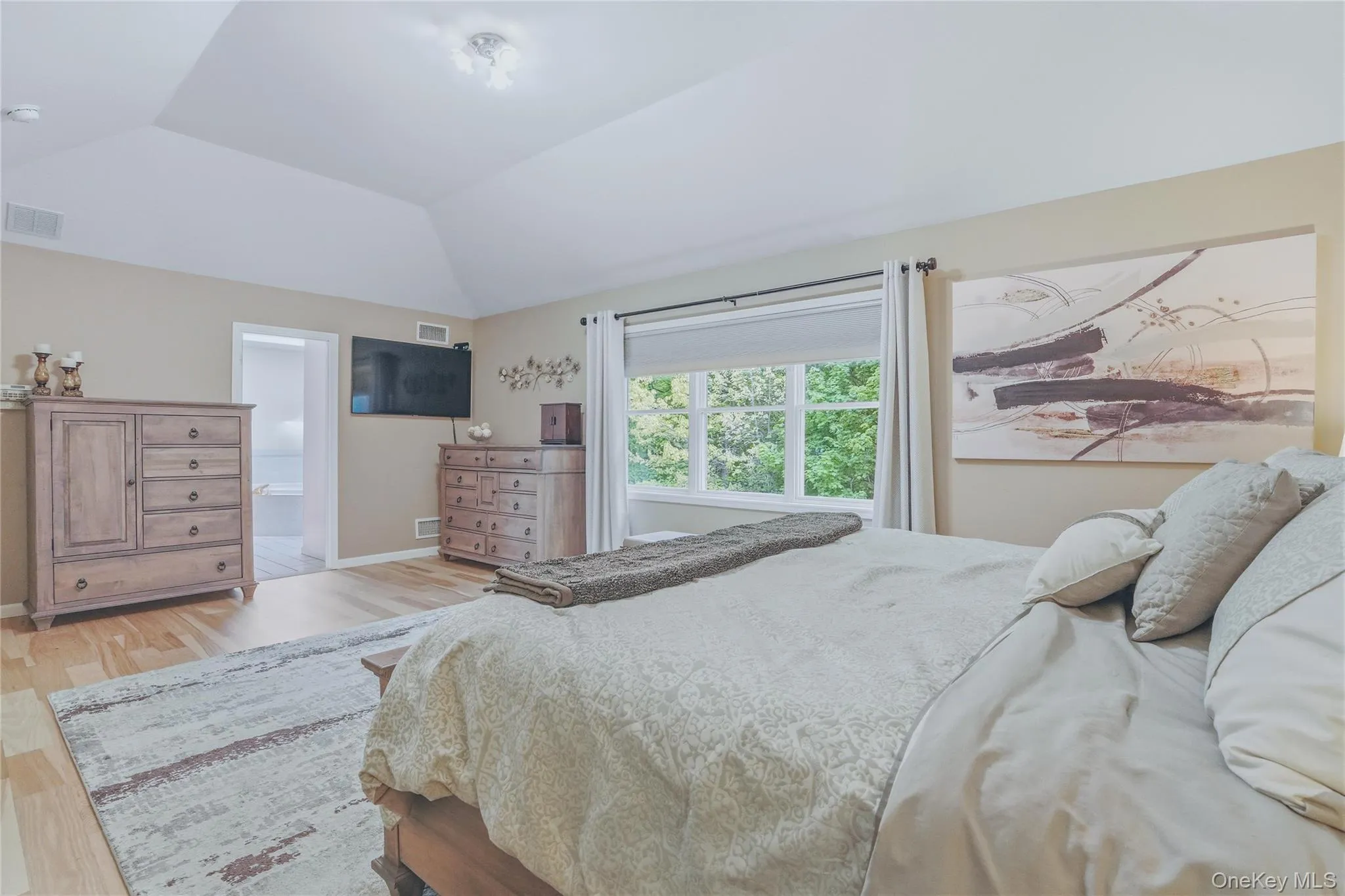 Serene primary bedroom with peaceful views overlooking the pool and surrounding woods. Serene primary bedroom with peaceful views overlooking the pool and surrounding woods.