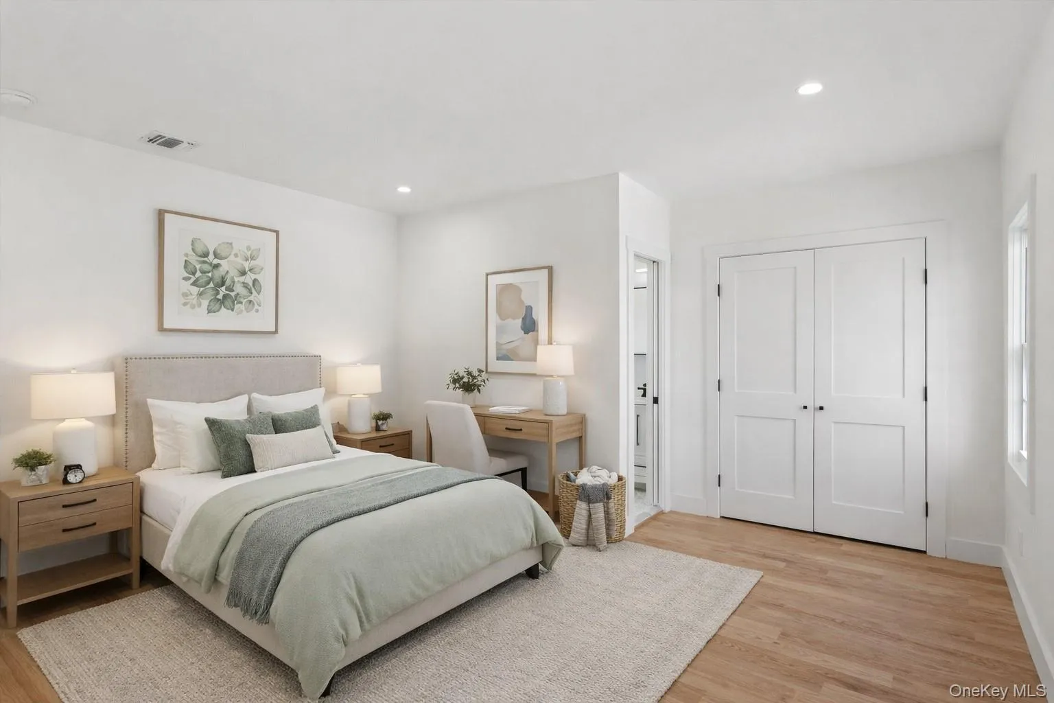 Staged Photo This bright room features light hardwood floors, recessed lighting, and white walls Staged Photo This bright room features light hardwood floors, recessed lighting, and white walls