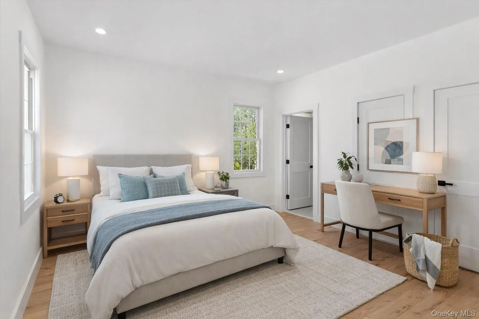 Staged Photo This room features hardwood flooring, recessed lighting, and a window providing natural light Staged Photo This room features hardwood flooring, recessed lighting, and a window providing natural light