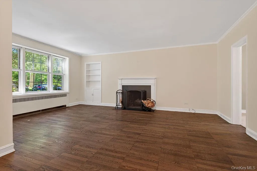 A working wood burning fireplace and three windows provide lots of light, and A working wood burning fireplace and three windows provide lots of light, and