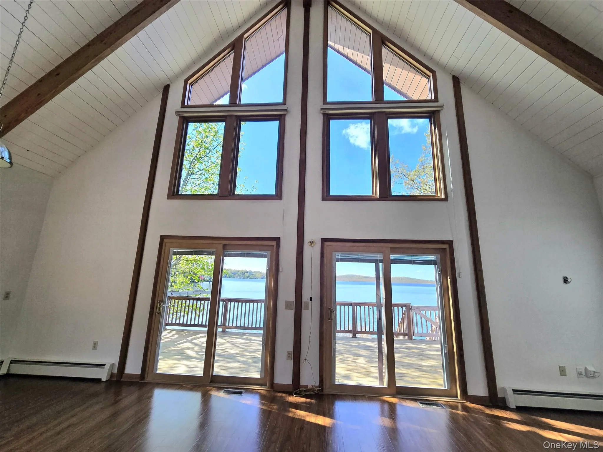 Vaulted ceiling with exposed wood beams and water view Vaulted ceiling with exposed wood beams and water view