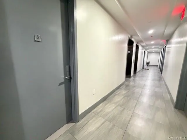 Corridor with baseboards and elevator Corridor with baseboards and elevator