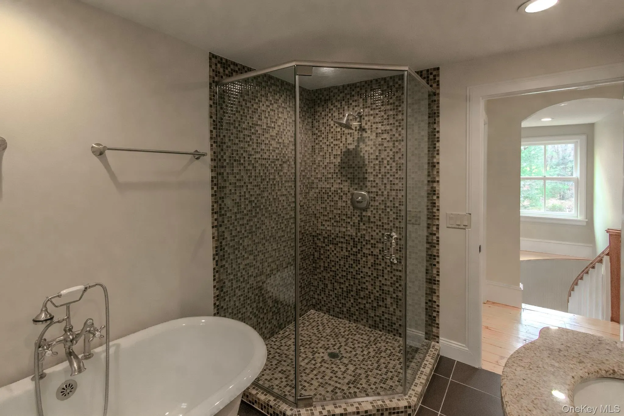 Bathroom featuring tile patterned floors and shower with separate bathtub Bathroom featuring tile patterned floors and shower with separate bathtub