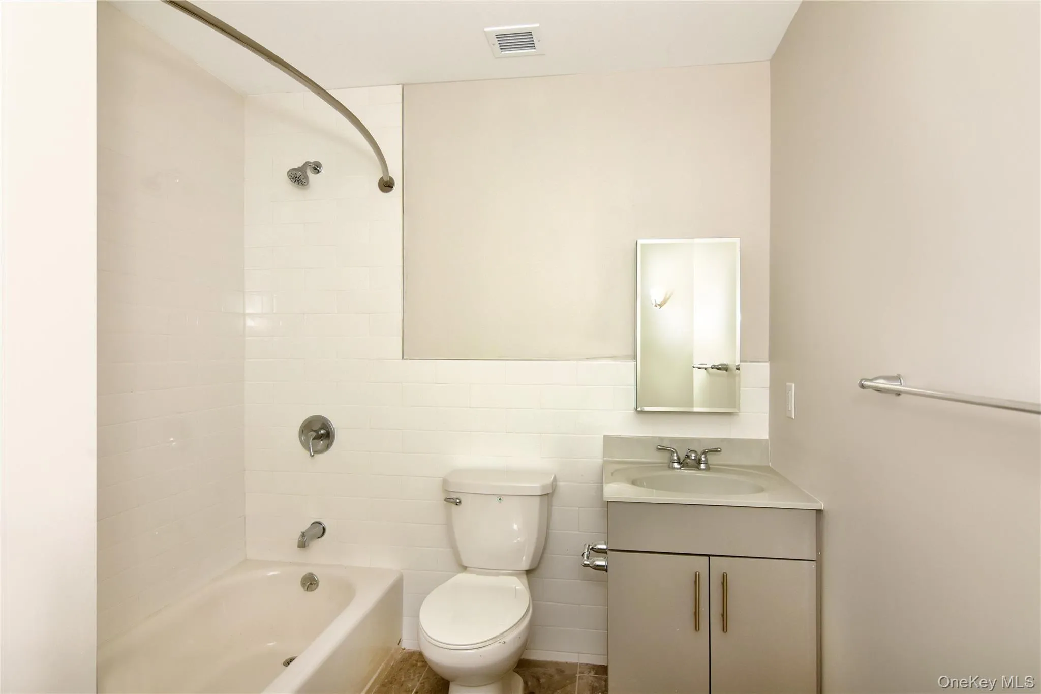 Full bath with vanity, washtub / shower combination, and tile walls Full bath with vanity, washtub / shower combination, and tile walls