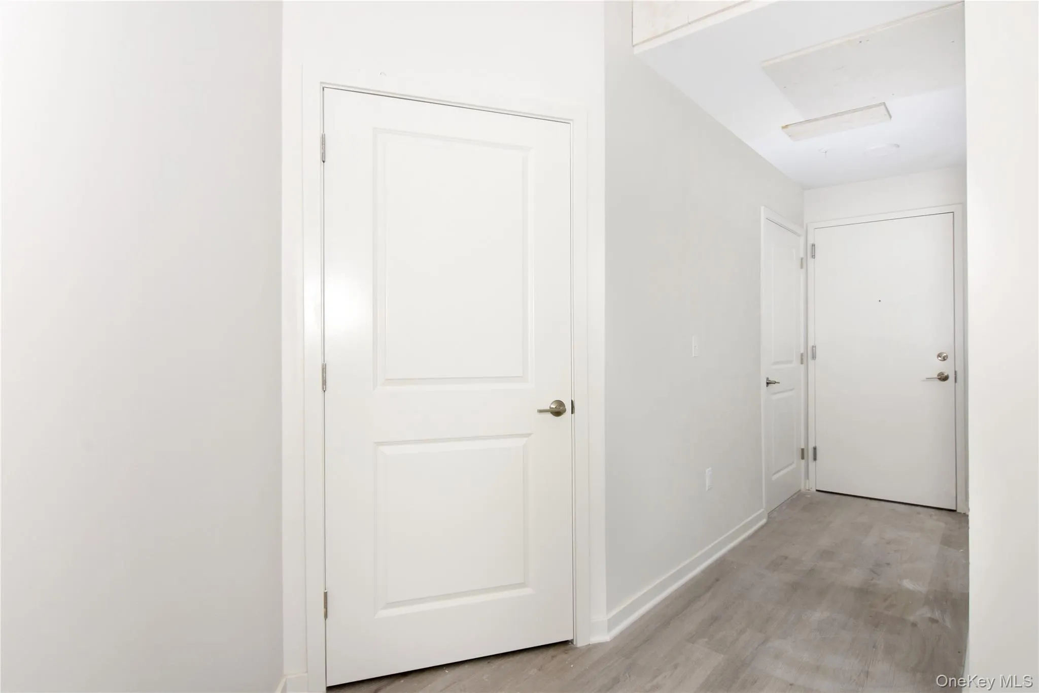 Hallway with baseboards and light wood finished floors Hallway with baseboards and light wood finished floors