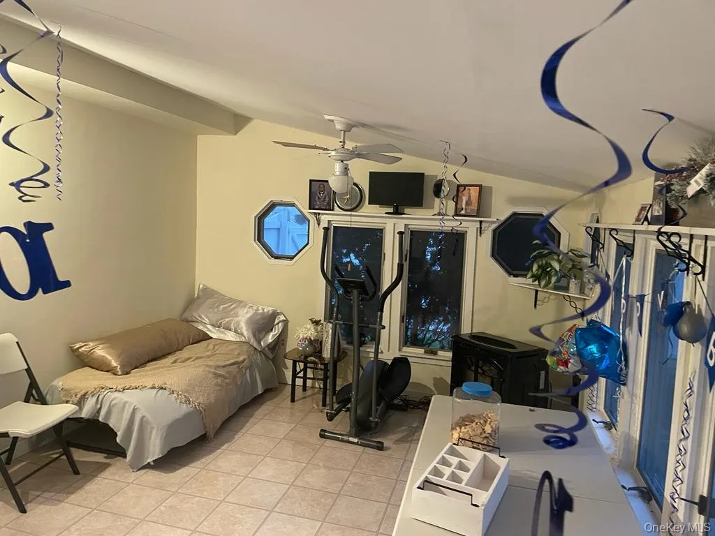 Tiled bedroom with lofted ceiling Tiled bedroom with lofted ceiling