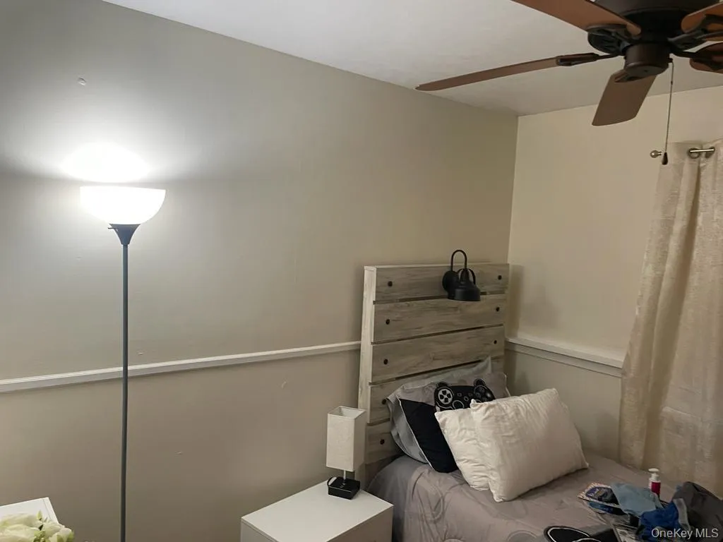 Bedroom featuring a ceiling fan Bedroom featuring a ceiling fan