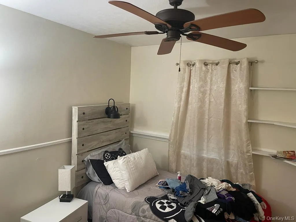 Bedroom featuring a ceiling fan Bedroom featuring a ceiling fan