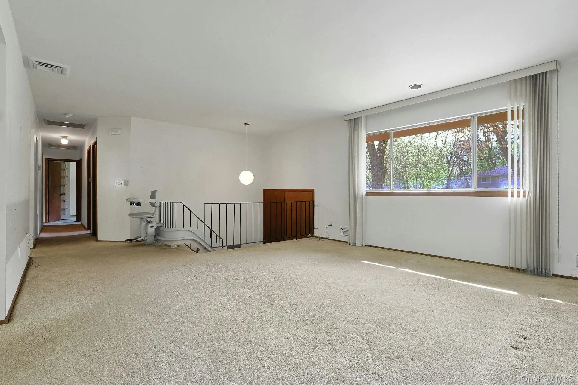 View of front doors and large sunny living room View of front doors and large sunny living room