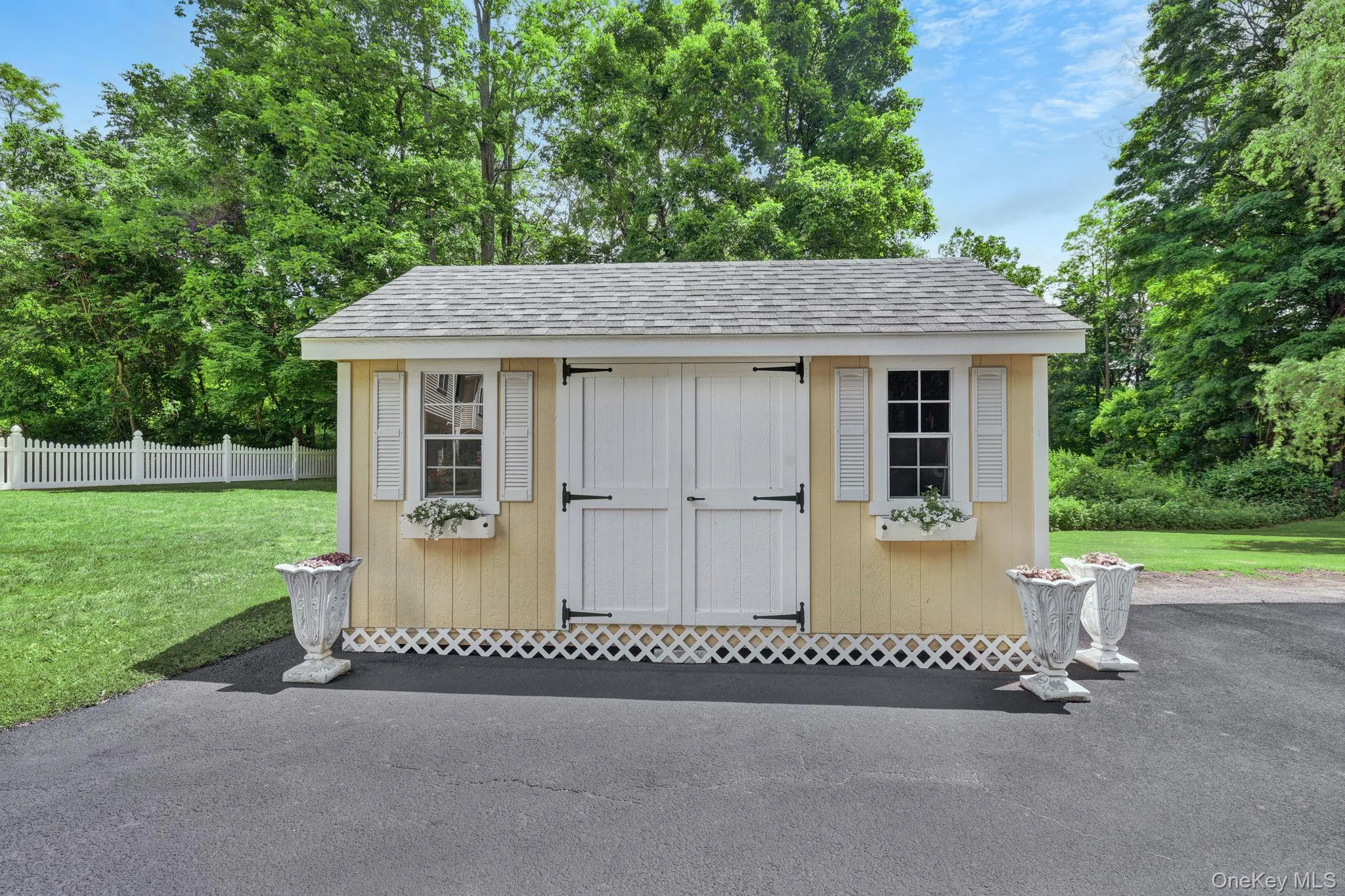 Yellow exterior shed featuring white barn doors and windows with decorative shutters. Moveable shed for extra storage! Yellow exterior shed featuring white barn doors and windows with decorative shutters. Moveable shed for extra storage!