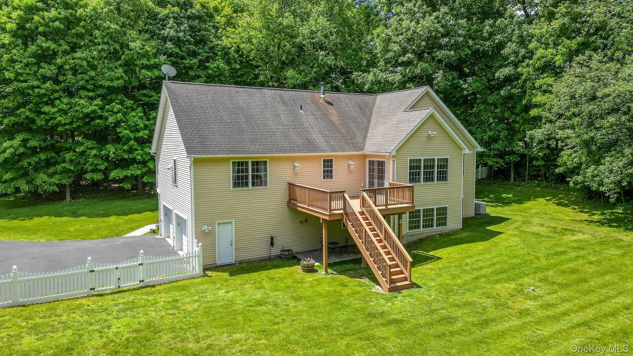 The view of the rear of house with beautiful deck overlooking park like property. The view of the rear of house with beautiful deck overlooking park like property.