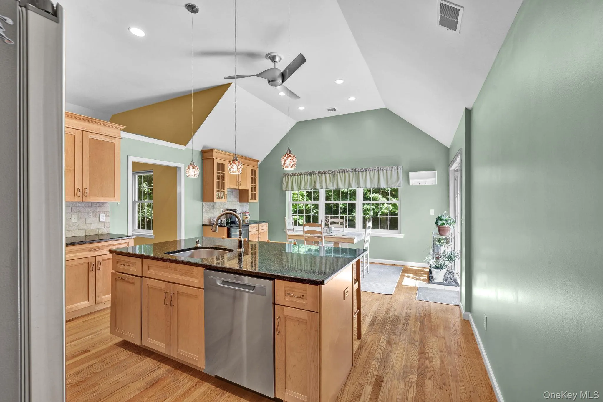 Kitchen also has wood-finished flooring, a large wood cabinet central island with a built-in sink and stainless steel dishwasher. Kitchen also has wood-finished flooring, a large wood cabinet central island with a built-in sink and stainless steel dishwasher.