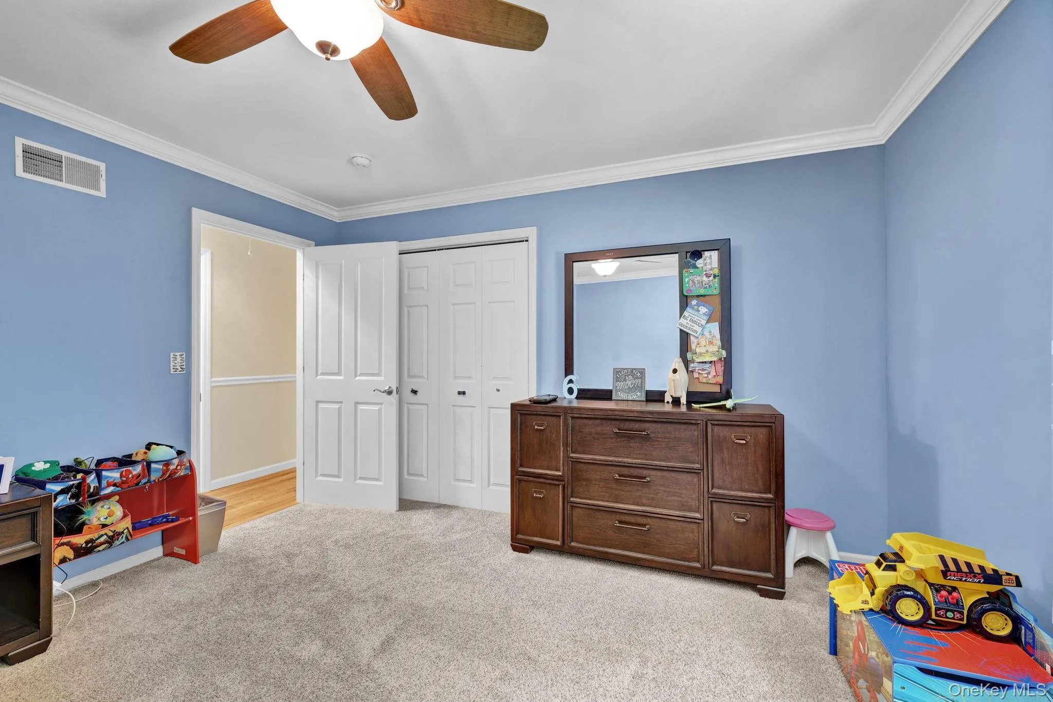 The room features light-toned carpet flooring with hardwood underneath The room features light-toned carpet flooring with hardwood underneath