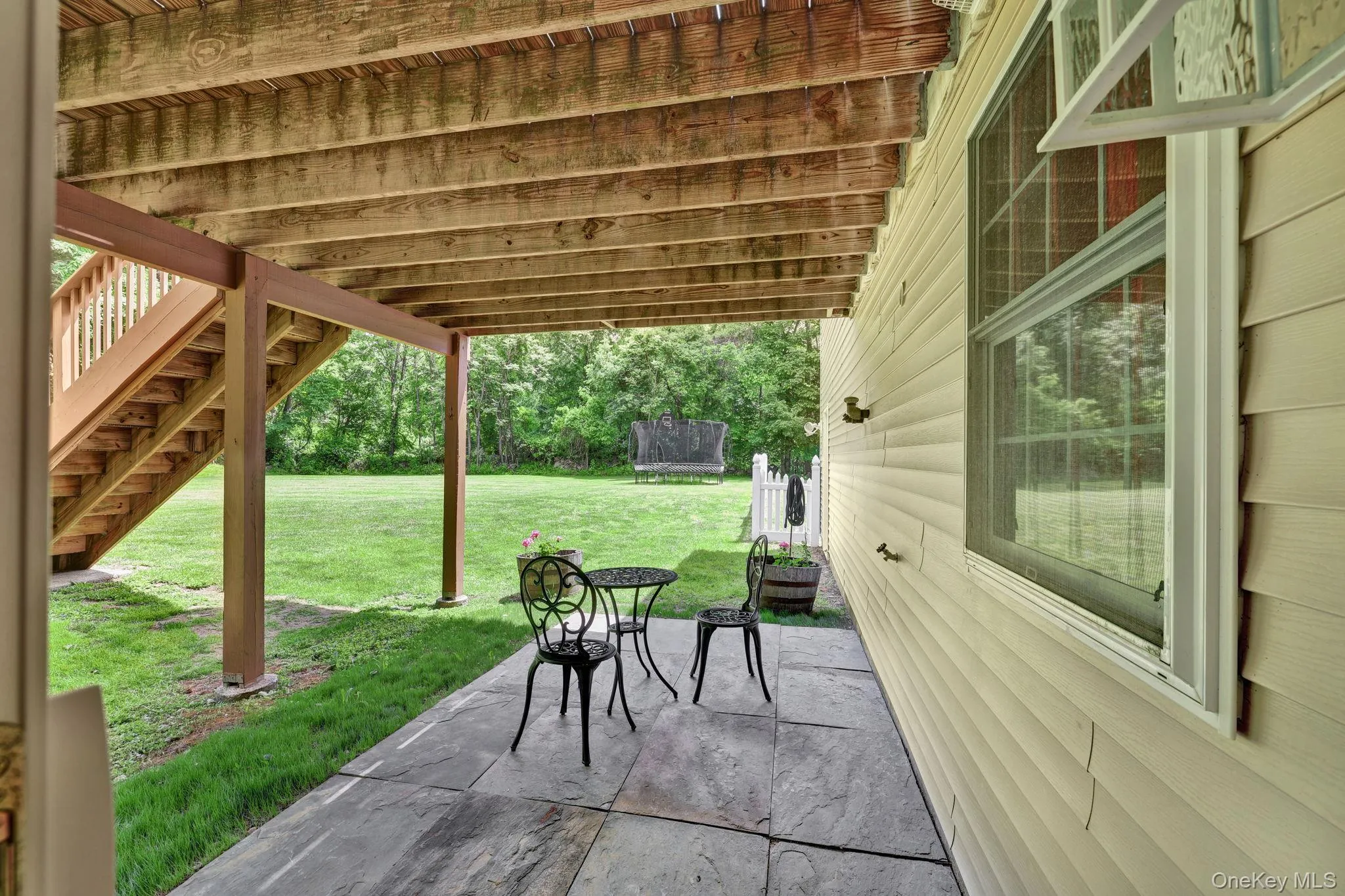 Covered patio featuring stone tile flooring Covered patio featuring stone tile flooring
