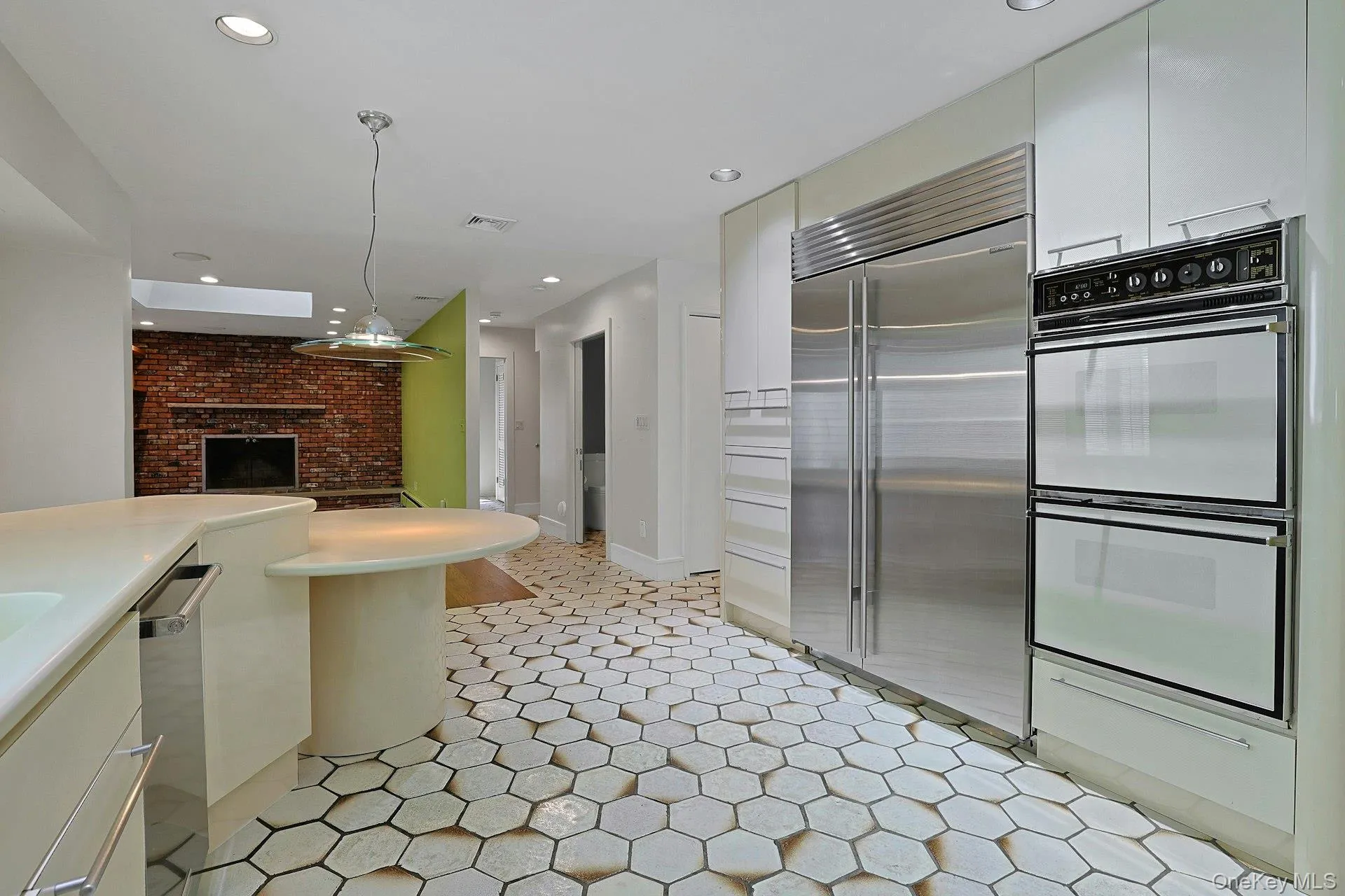 A view of the double ovens, Sub Zero built in refrigerator & beyond A view of the double ovens, Sub Zero built in refrigerator & beyond