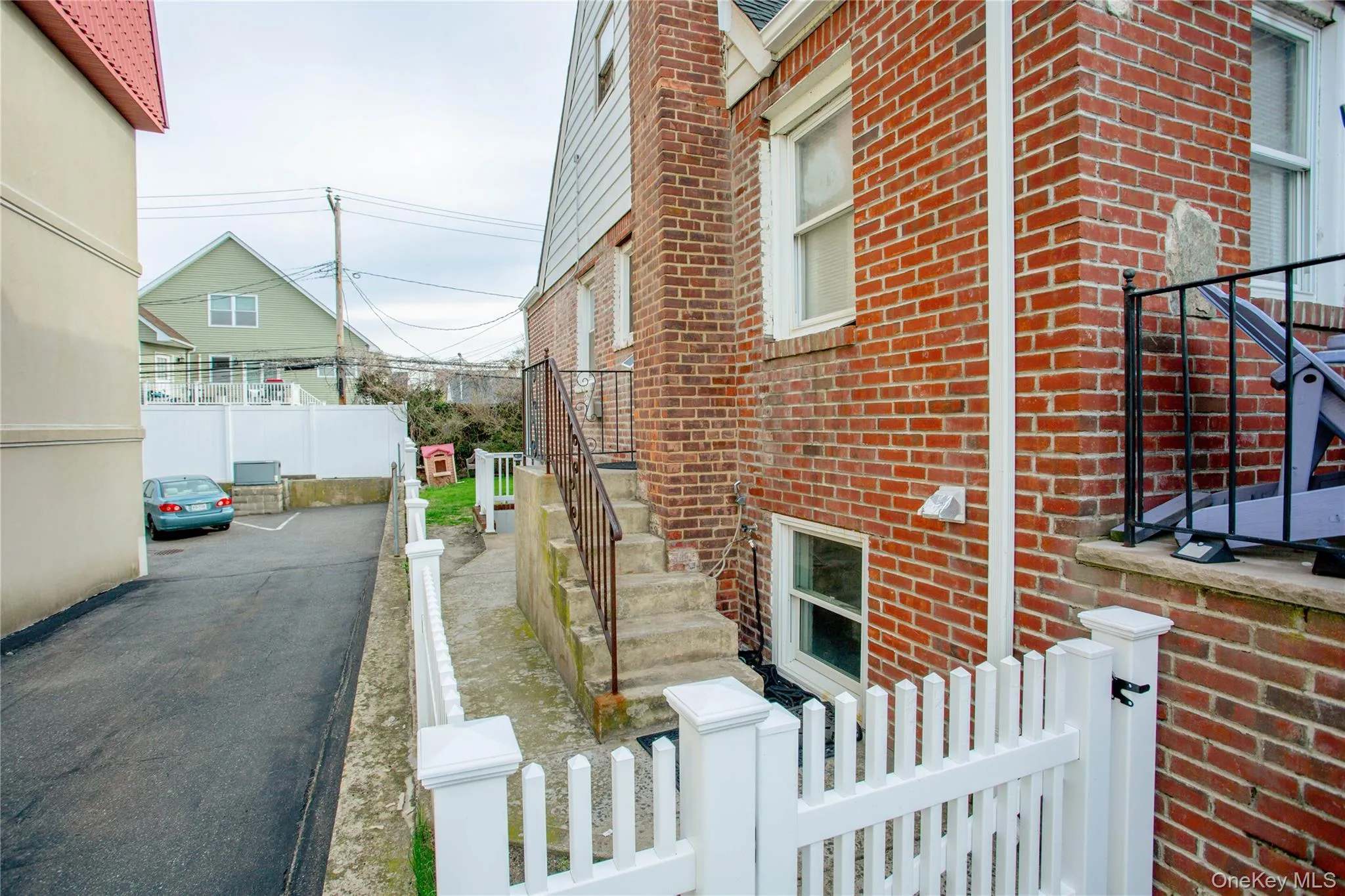 View of home's exterior with brick siding and fence View of home's exterior with brick siding and fence