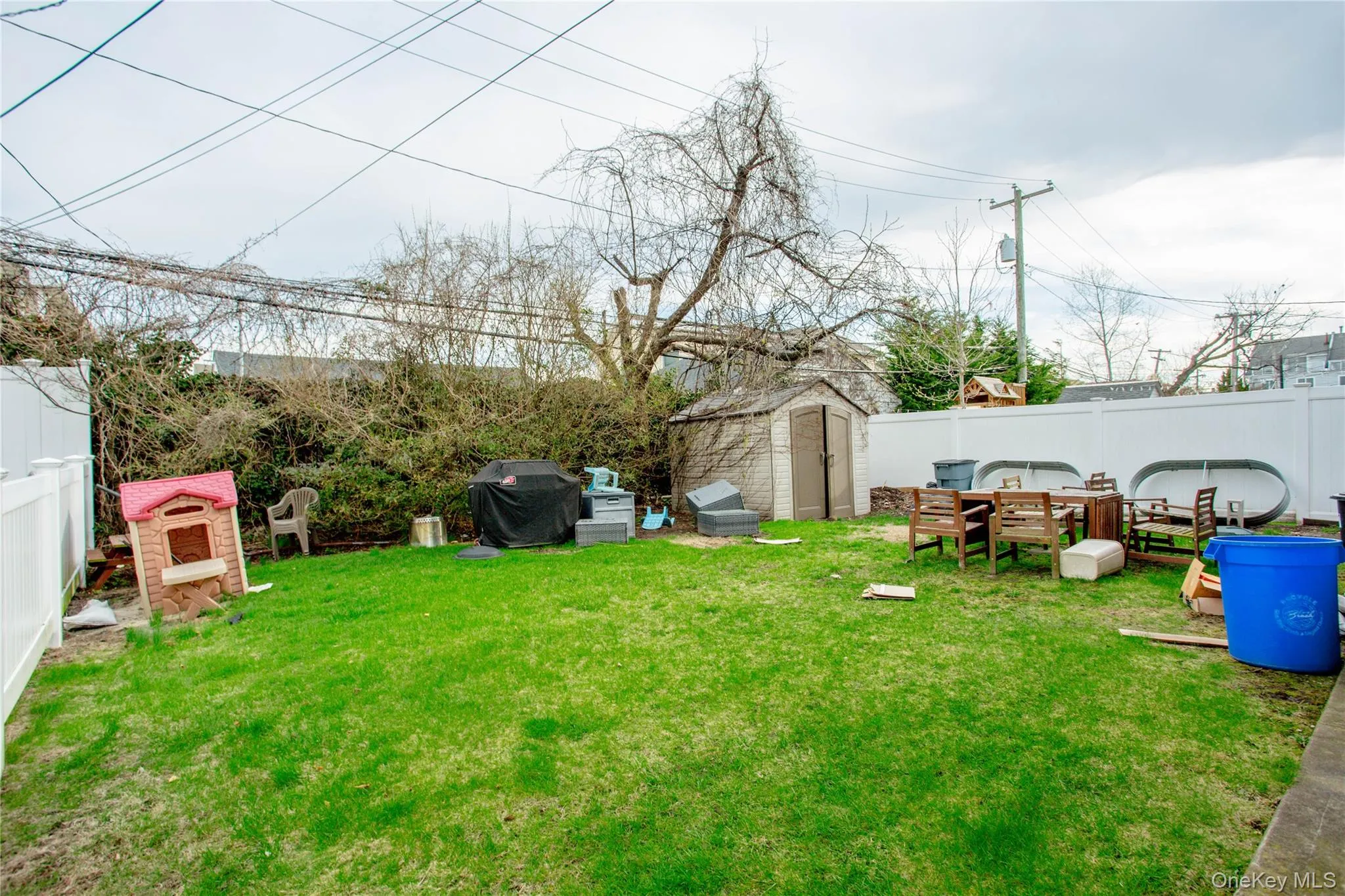 View of yard featuring a storage shed, a fenced backyard, and an outbuilding View of yard featuring a storage shed, a fenced backyard, and an outbuilding