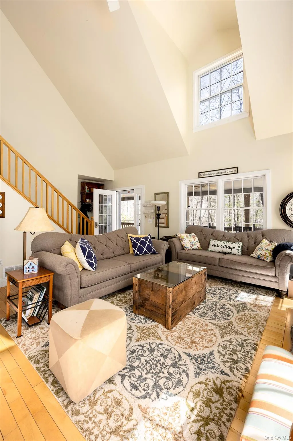 Living room with light wood finished floors and vaulted ceiling Living room with light wood finished floors and vaulted ceiling