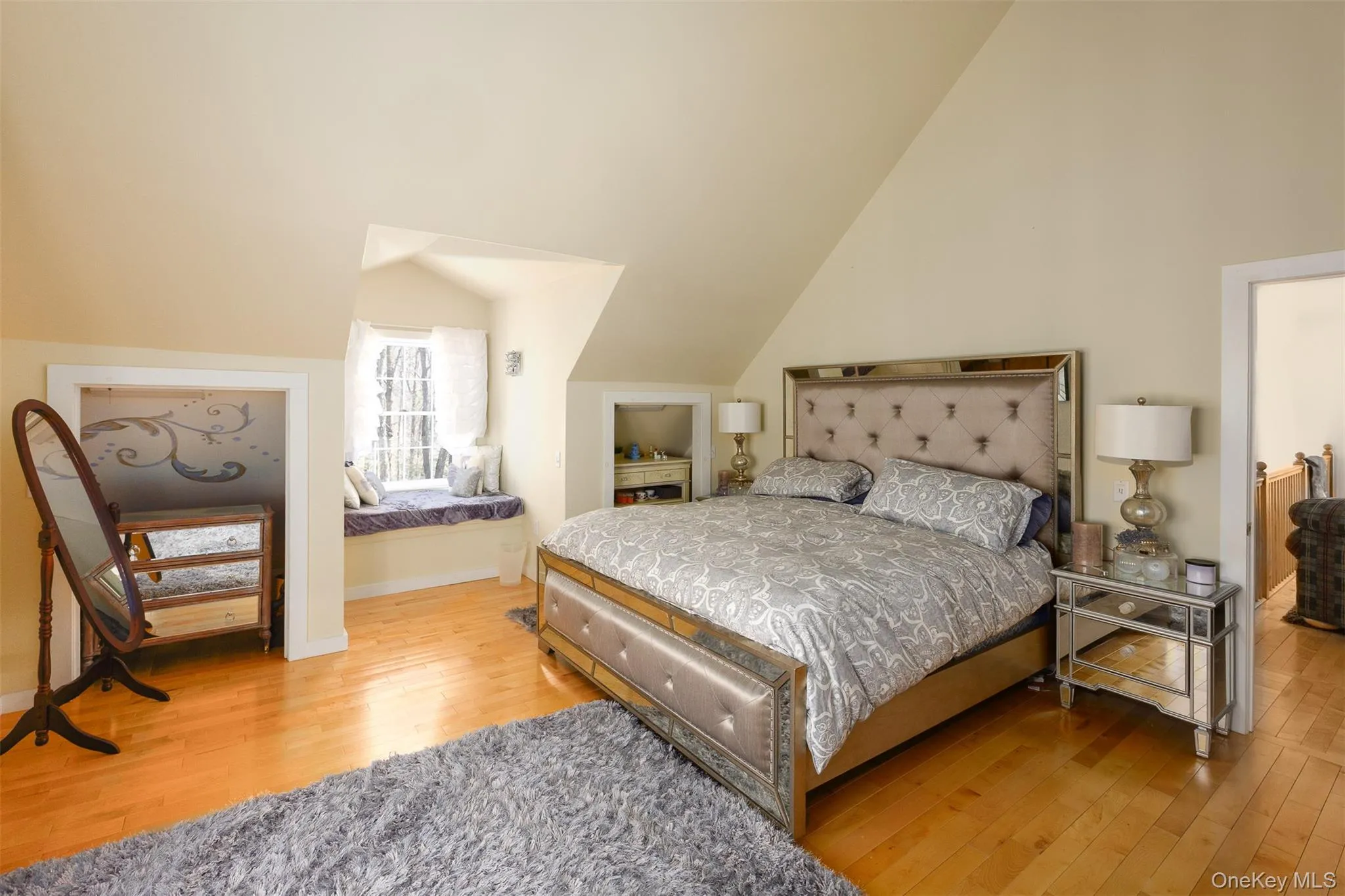 Bedroom with light wood-type flooring and vaulted ceiling Bedroom with light wood-type flooring and vaulted ceiling