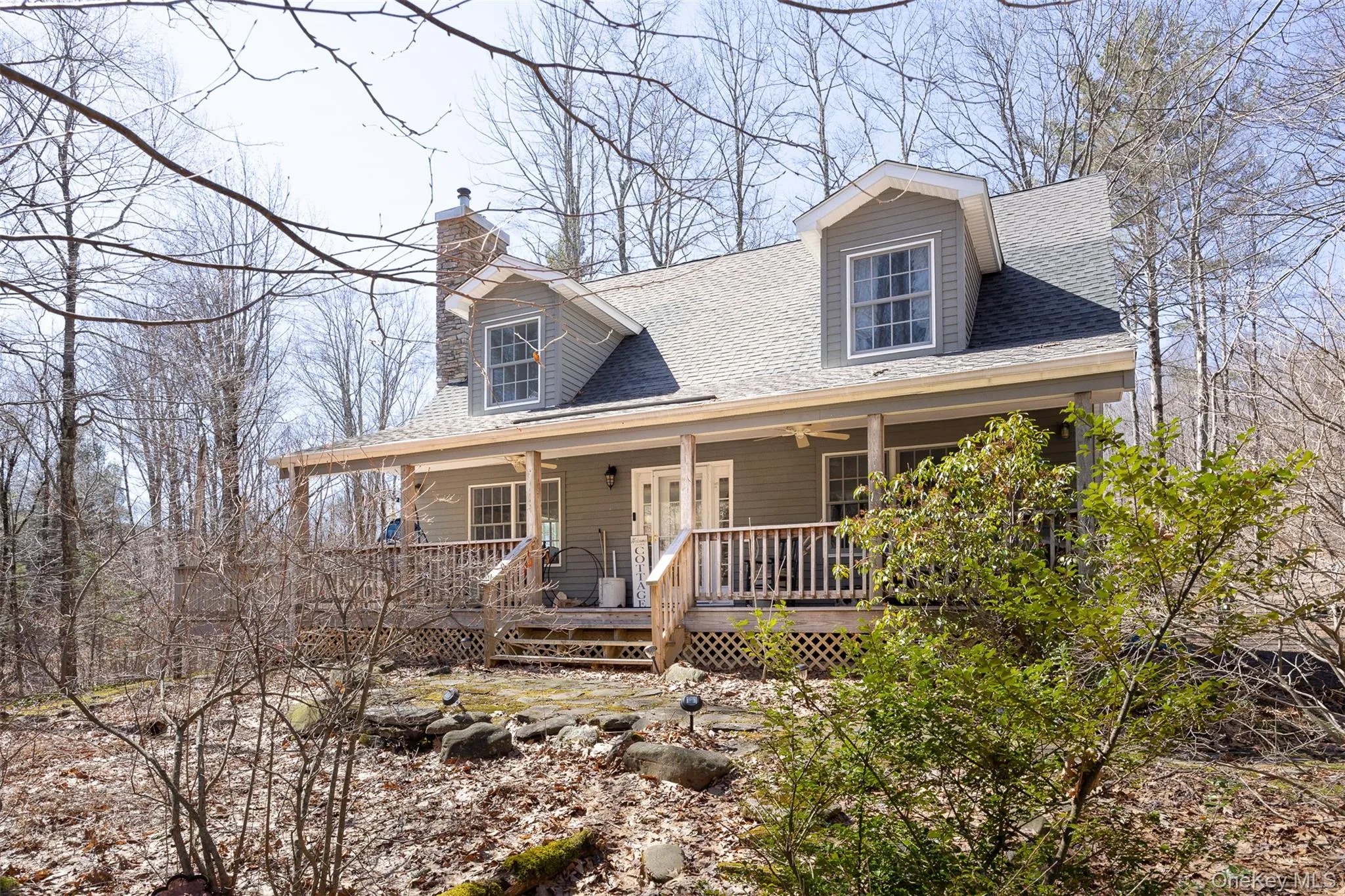 View of front of home with roof with shingles, a porch, and a chimney View of front of home with roof with shingles, a porch, and a chimney