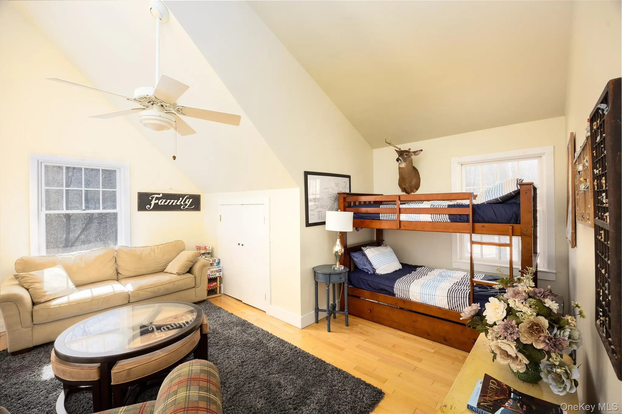 Bedroom featuring light wood-type flooring, ceiling fan, and lofted ceiling Bedroom featuring light wood-type flooring, ceiling fan, and lofted ceiling