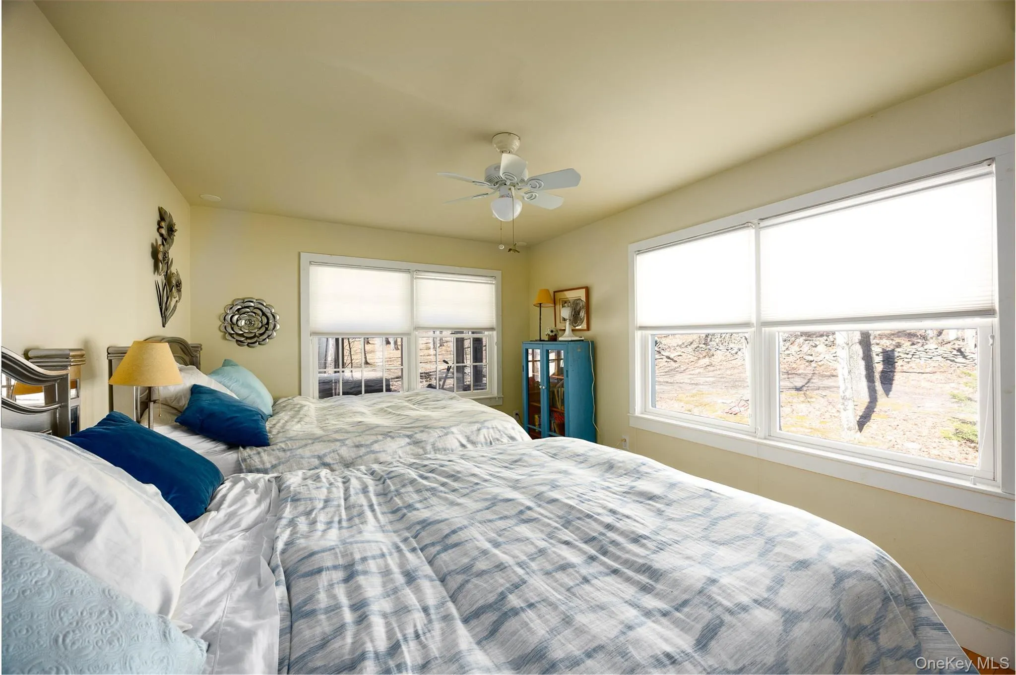 Bedroom with ceiling fan and multiple windows Bedroom with ceiling fan and multiple windows