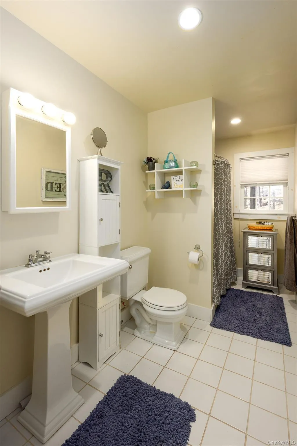 Bathroom with curtained shower, light tile patterned flooring, and recessed lighting Bathroom with curtained shower, light tile patterned flooring, and recessed lighting