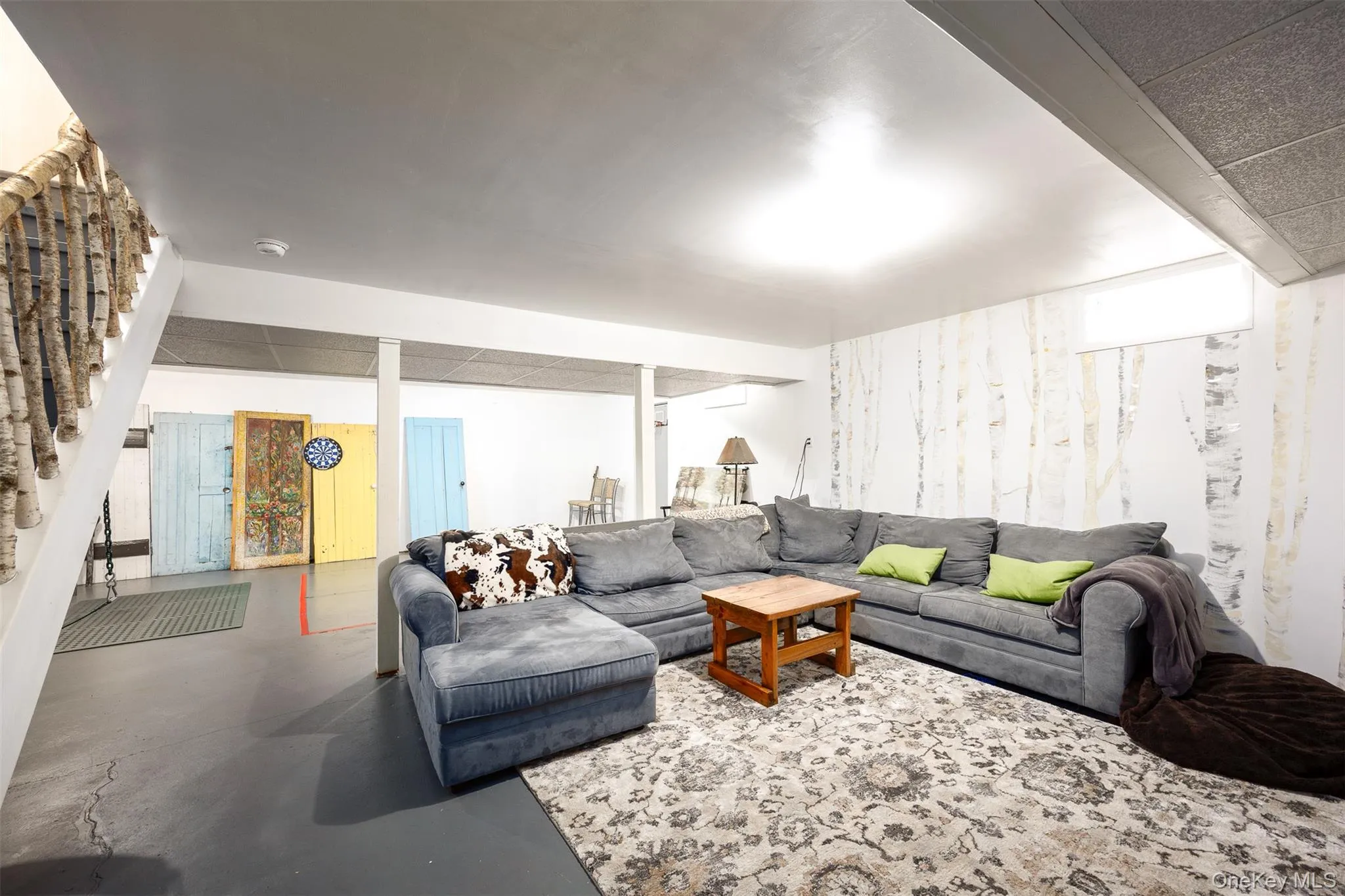 Living room with finished concrete floors and stairs Living room with finished concrete floors and stairs