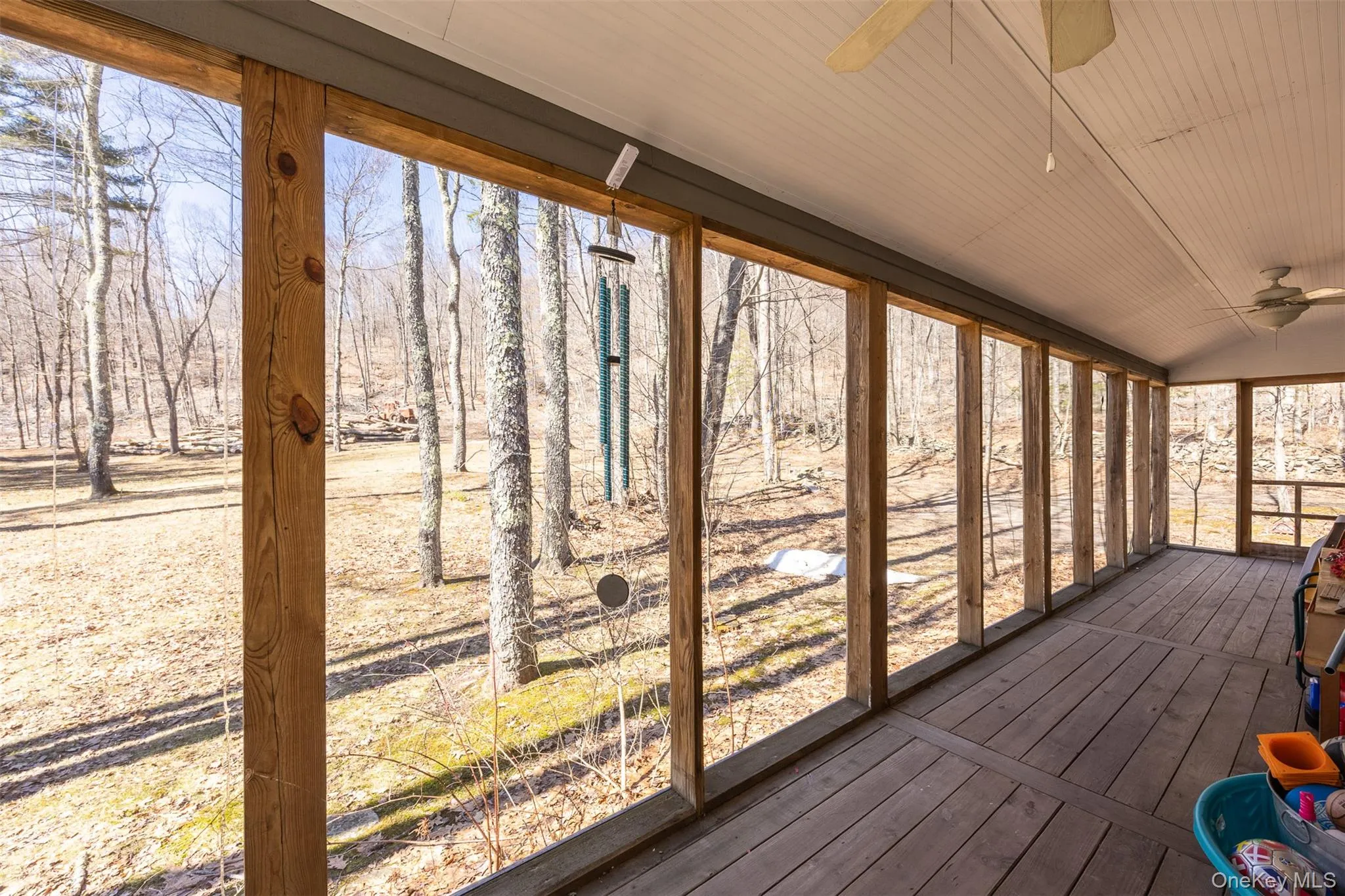 Unfurnished sunroom featuring a ceiling fan, vaulted ceiling, and a wooden deck Unfurnished sunroom featuring a ceiling fan, vaulted ceiling, and a wooden deck