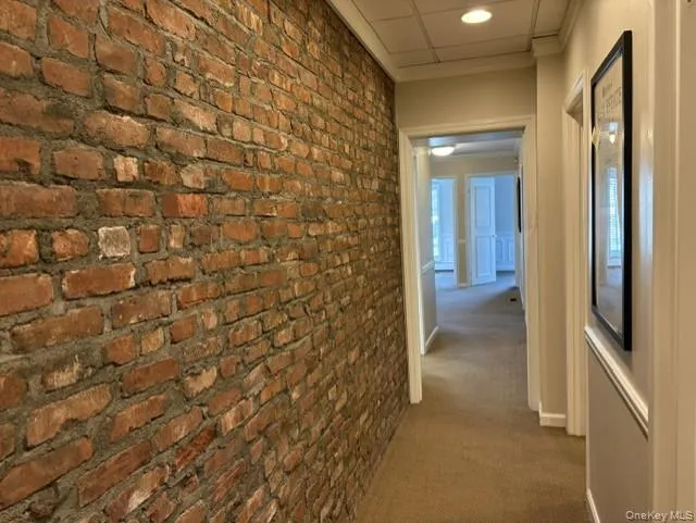 Attractive Exposed Brick Hallway leads to 2nd 1/2 Bath Attractive Exposed Brick Hallway leads to 2nd 1/2 Bath