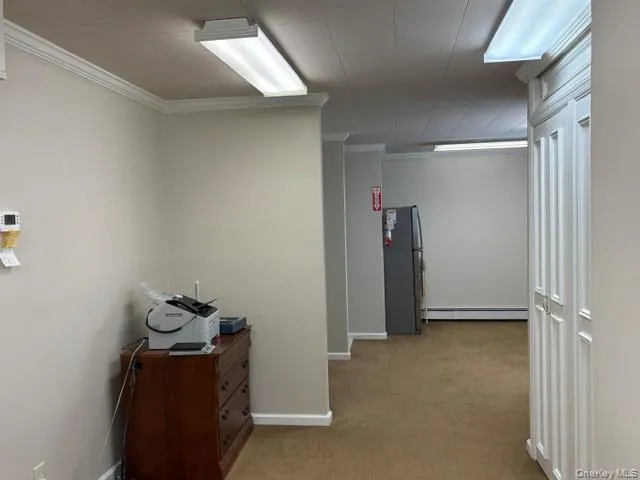 Large kitchenette area with sink and refrigerator leading to 1/2 bath. Large kitchenette area with sink and refrigerator leading to 1/2 bath.