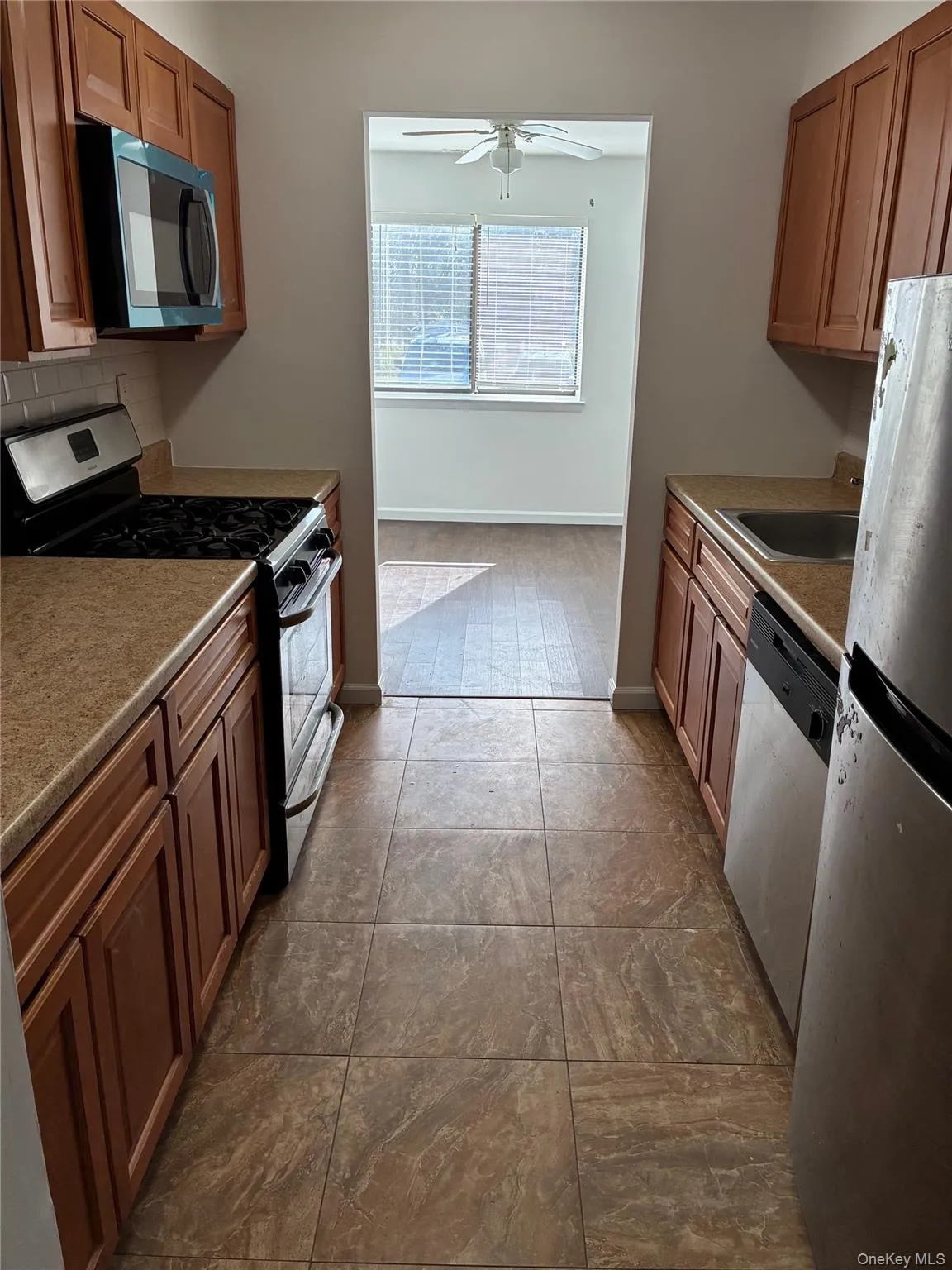 kitchen with tiled backsplash and new microwave kitchen with tiled backsplash and new microwave