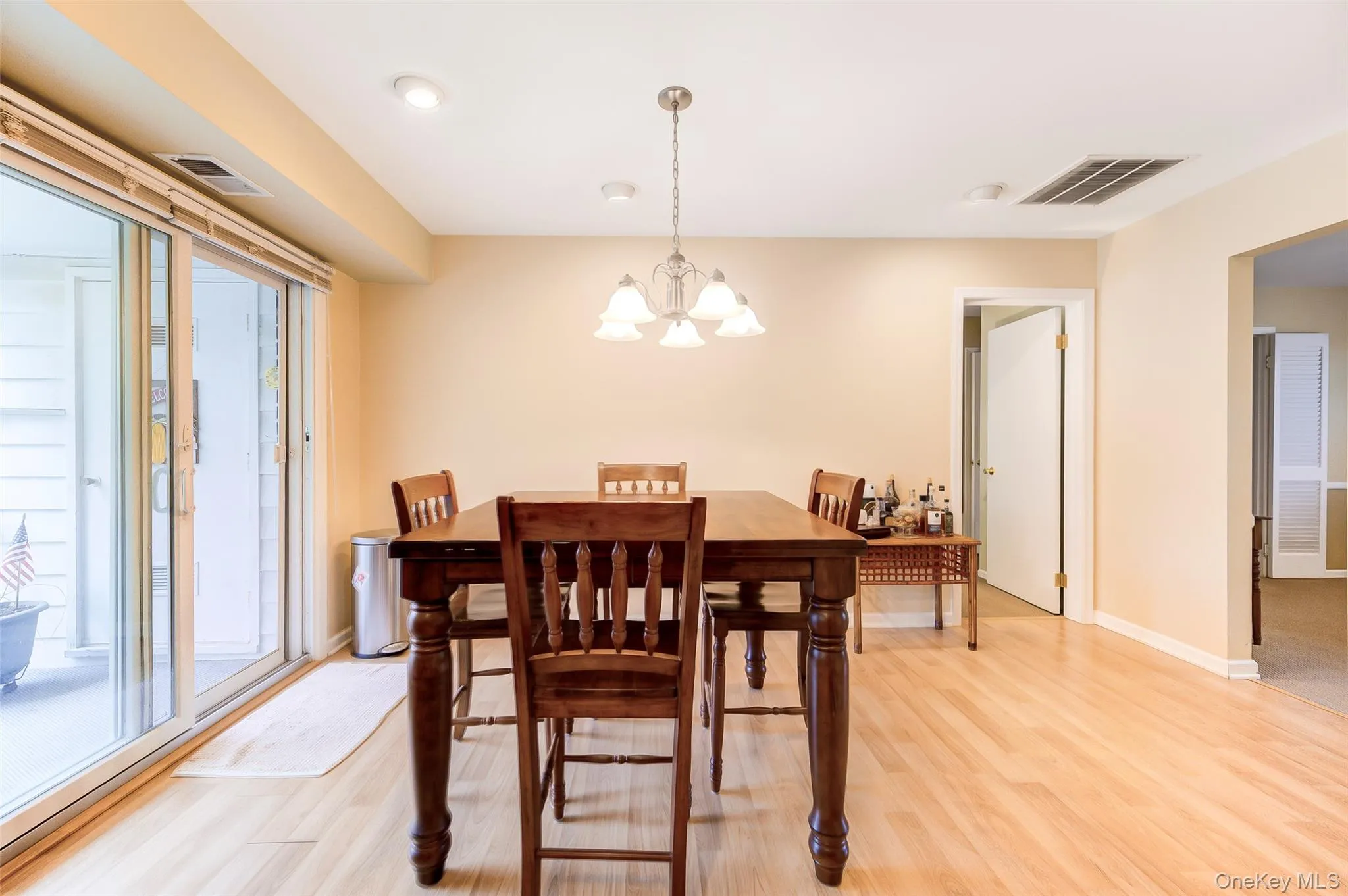 Dining area featuring wood-finish flooring, recessed lighting, and a glass sliding door to the exterior Dining area featuring wood-finish flooring, recessed lighting, and a glass sliding door to the exterior