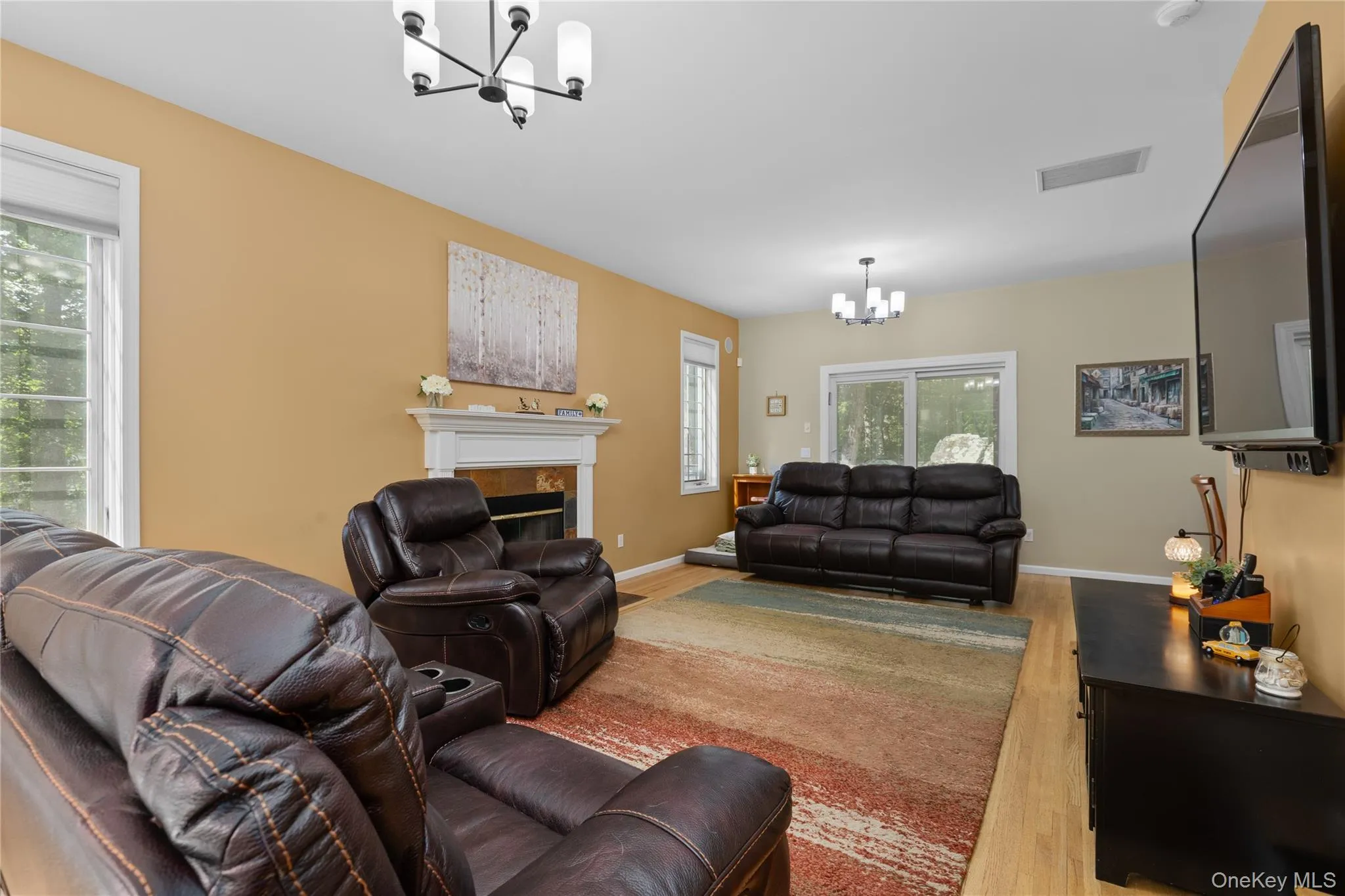 Cozy family room with fire place with sliders to deck Cozy family room with fire place with sliders to deck