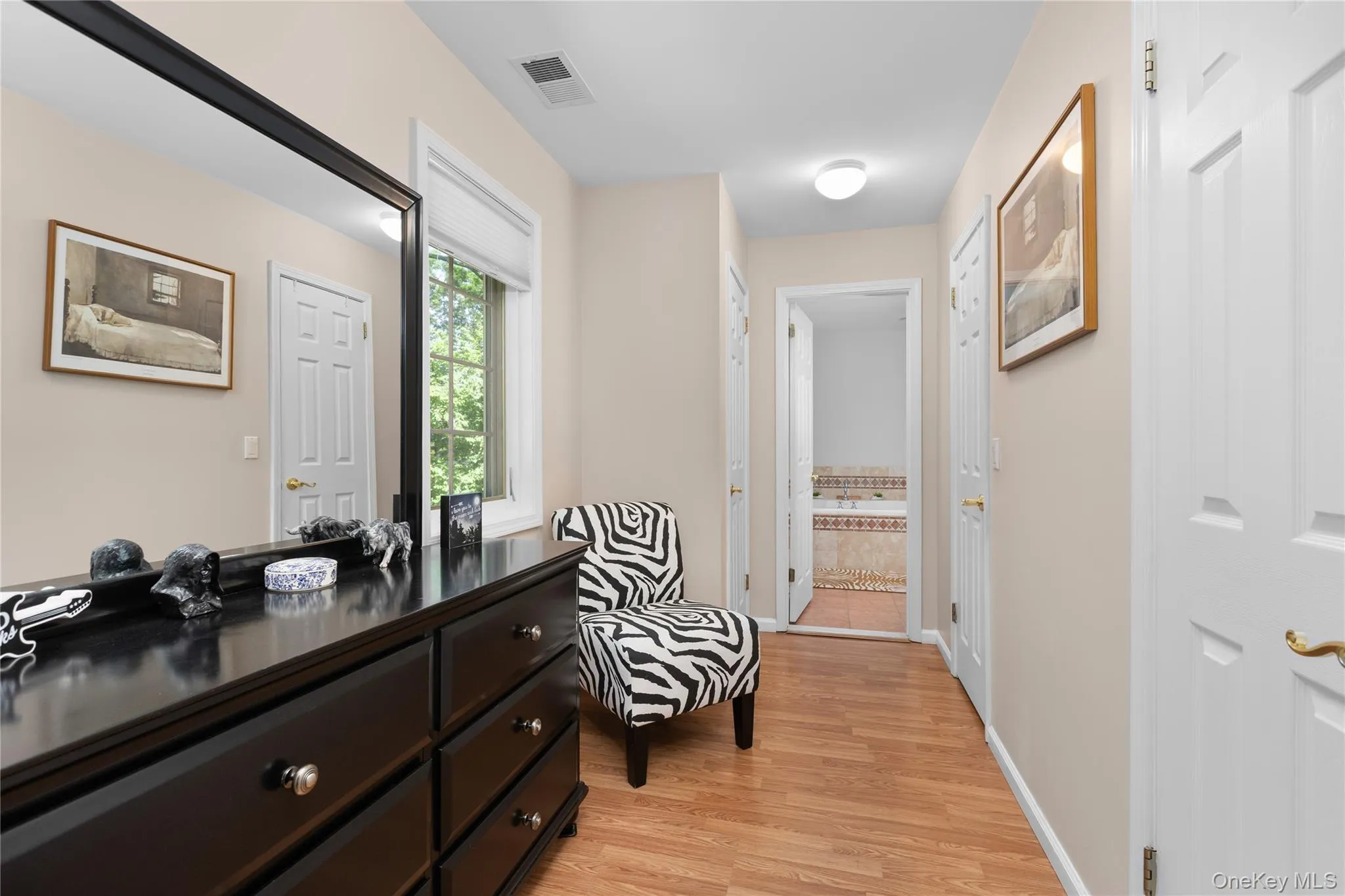 Primary bedroom with make up/dressing area with double closets Primary bedroom with make up/dressing area with double closets