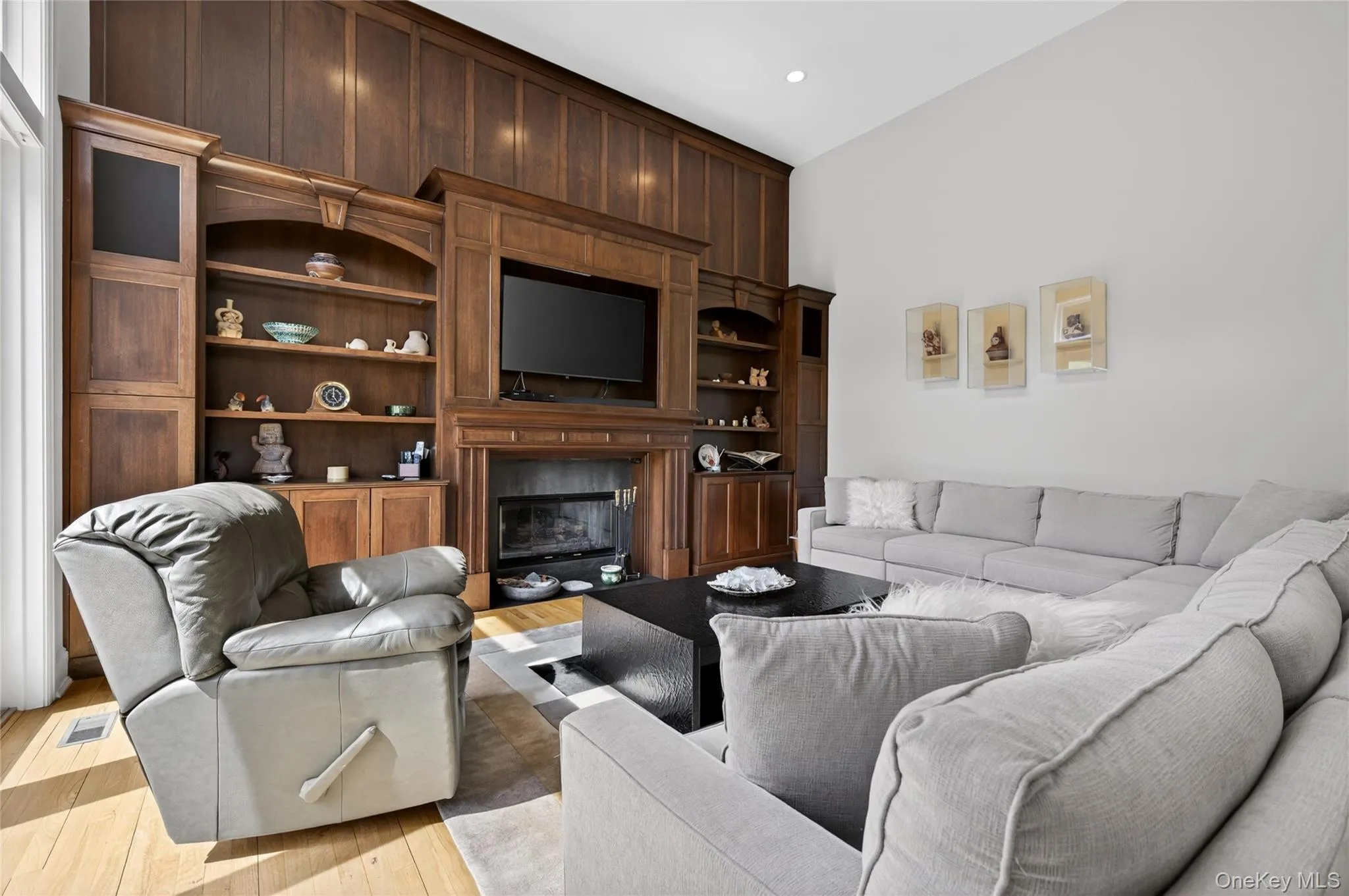 Den with built-in wood cabinetry and gas fireplace Den with built-in wood cabinetry and gas fireplace
