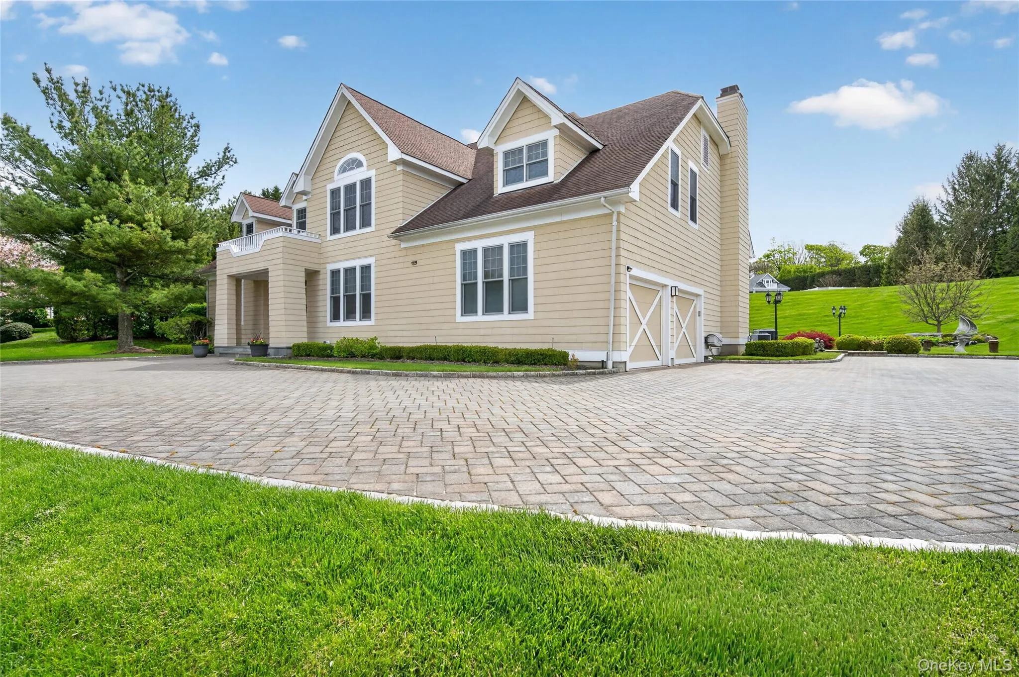 Front/side of home, with large paver driveway and 2 car garage Front/side of home, with large paver driveway and 2 car garage