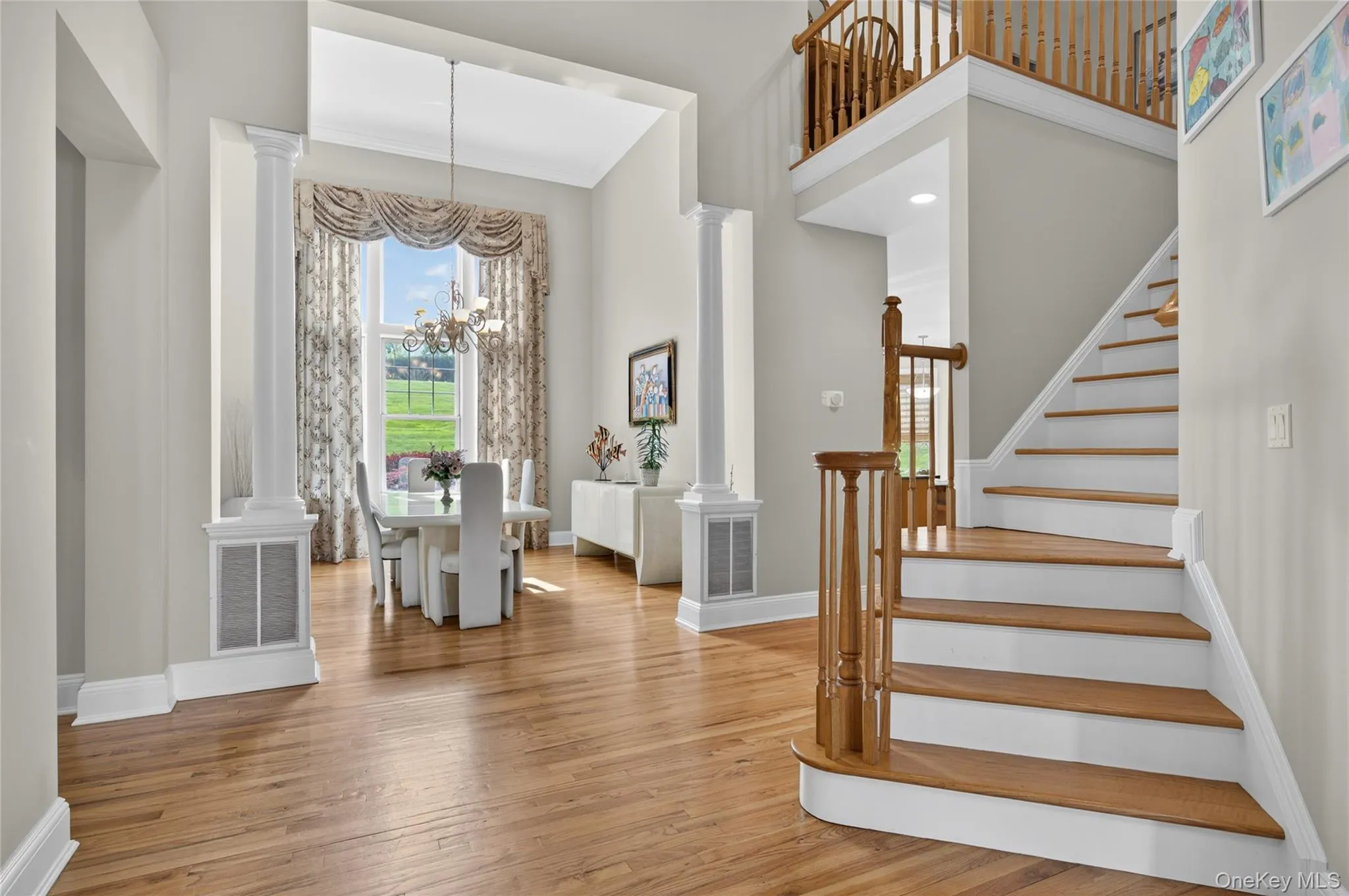 Entry with grand staircase to additional bedrooms and bathrooms Entry with grand staircase to additional bedrooms and bathrooms