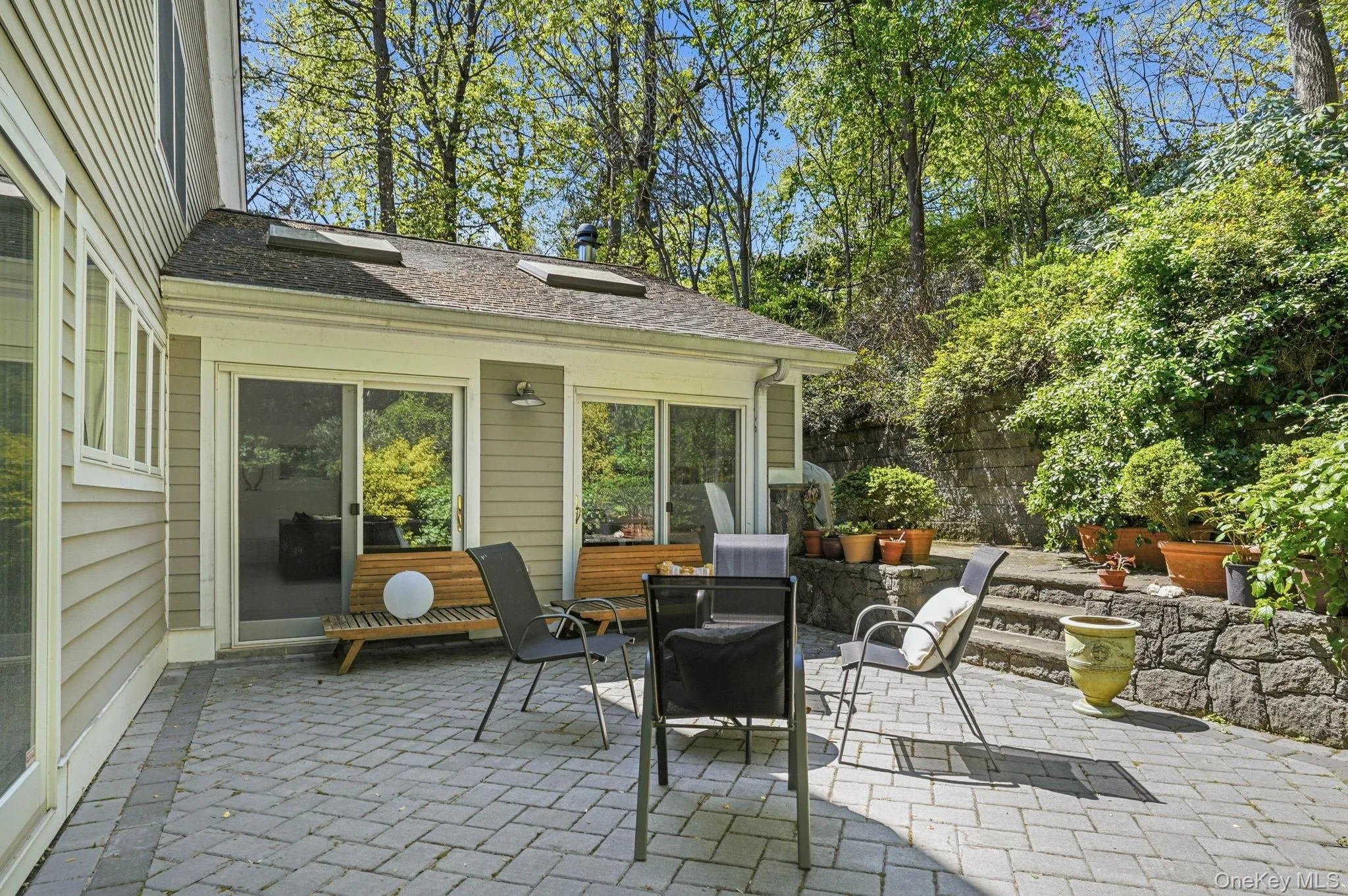 Lovely Patio in the back overlooks lush lanscaped gardens, including a waterfall! Lovely Patio in the back overlooks lush lanscaped gardens, including a waterfall!