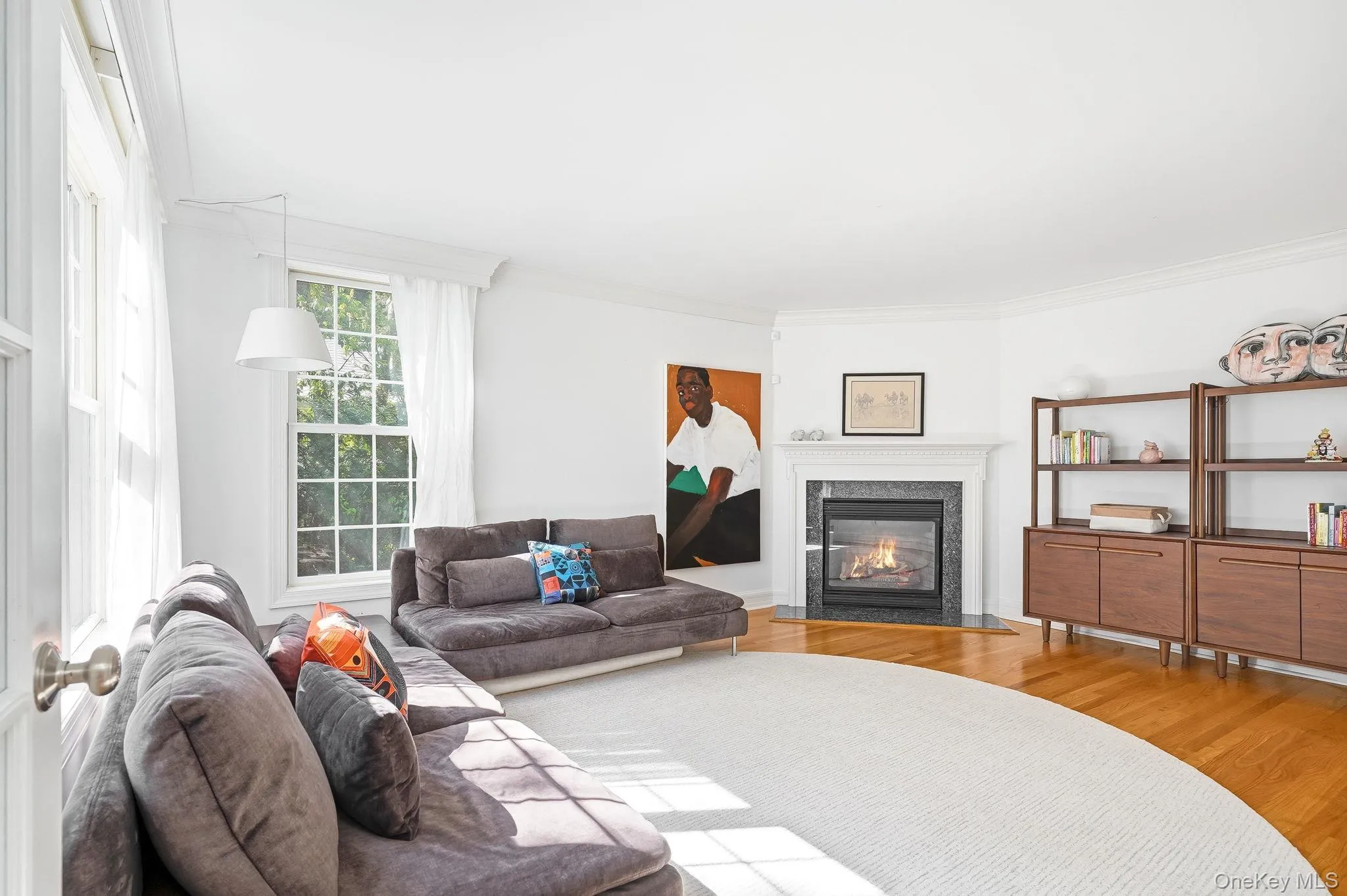 Living / sitting room to the left as you enter the home, featuring a gas fireplace. Living / sitting room to the left as you enter the home, featuring a gas fireplace.